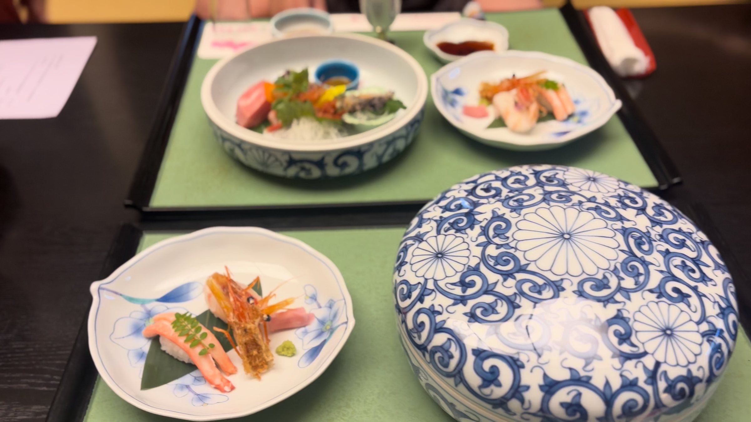 Small dishes and the lidded bowl on the dinner tray.
