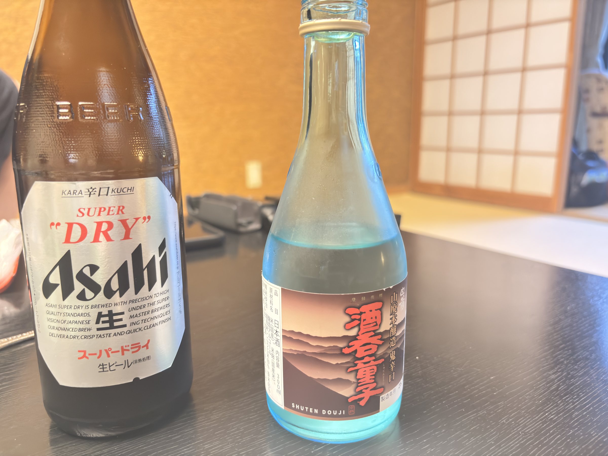 A bottle of draft beer beside Shuten Doji sake.