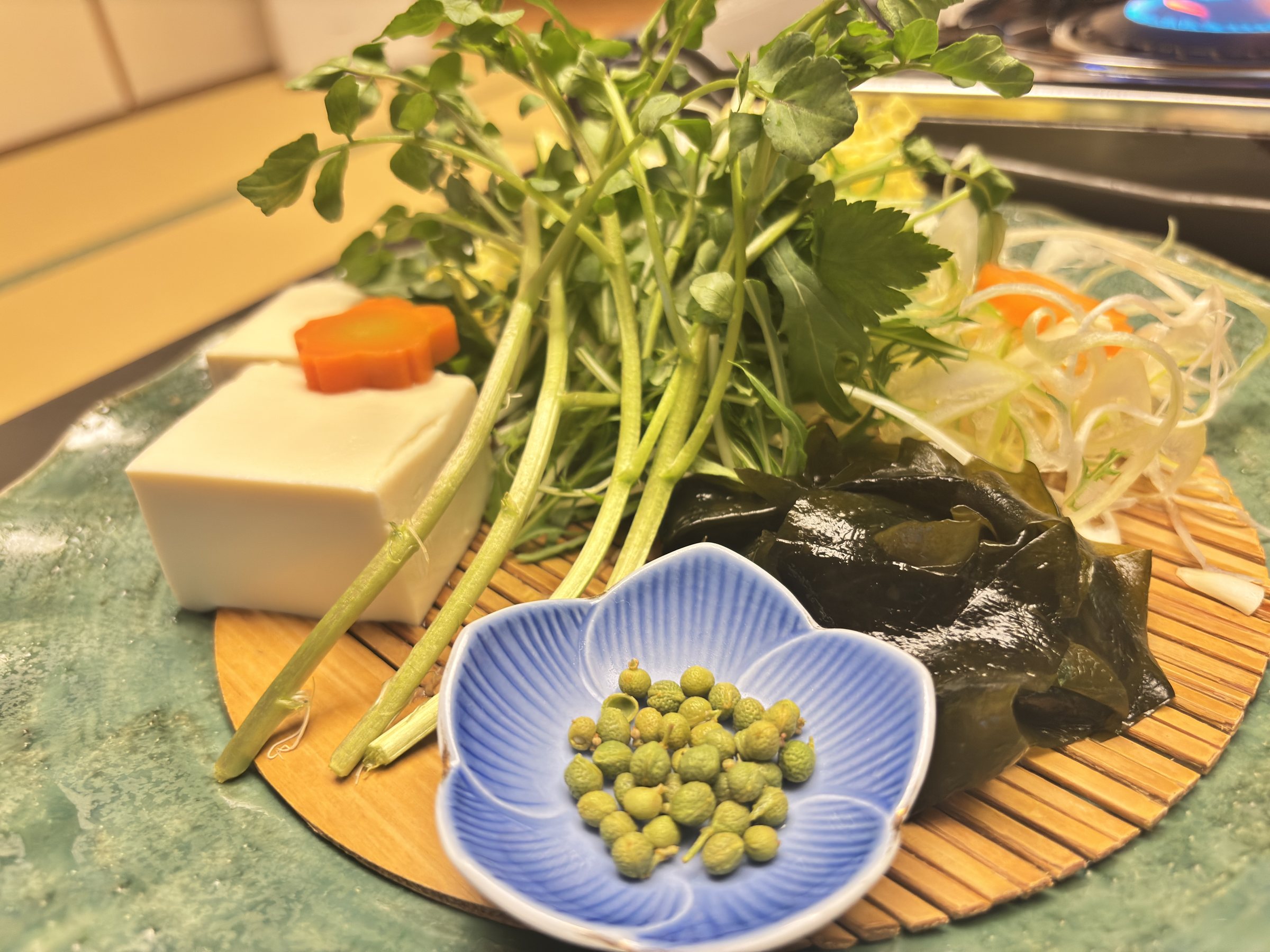 Watercress, tofu and a dish of green sansho berries for the hotpot.
