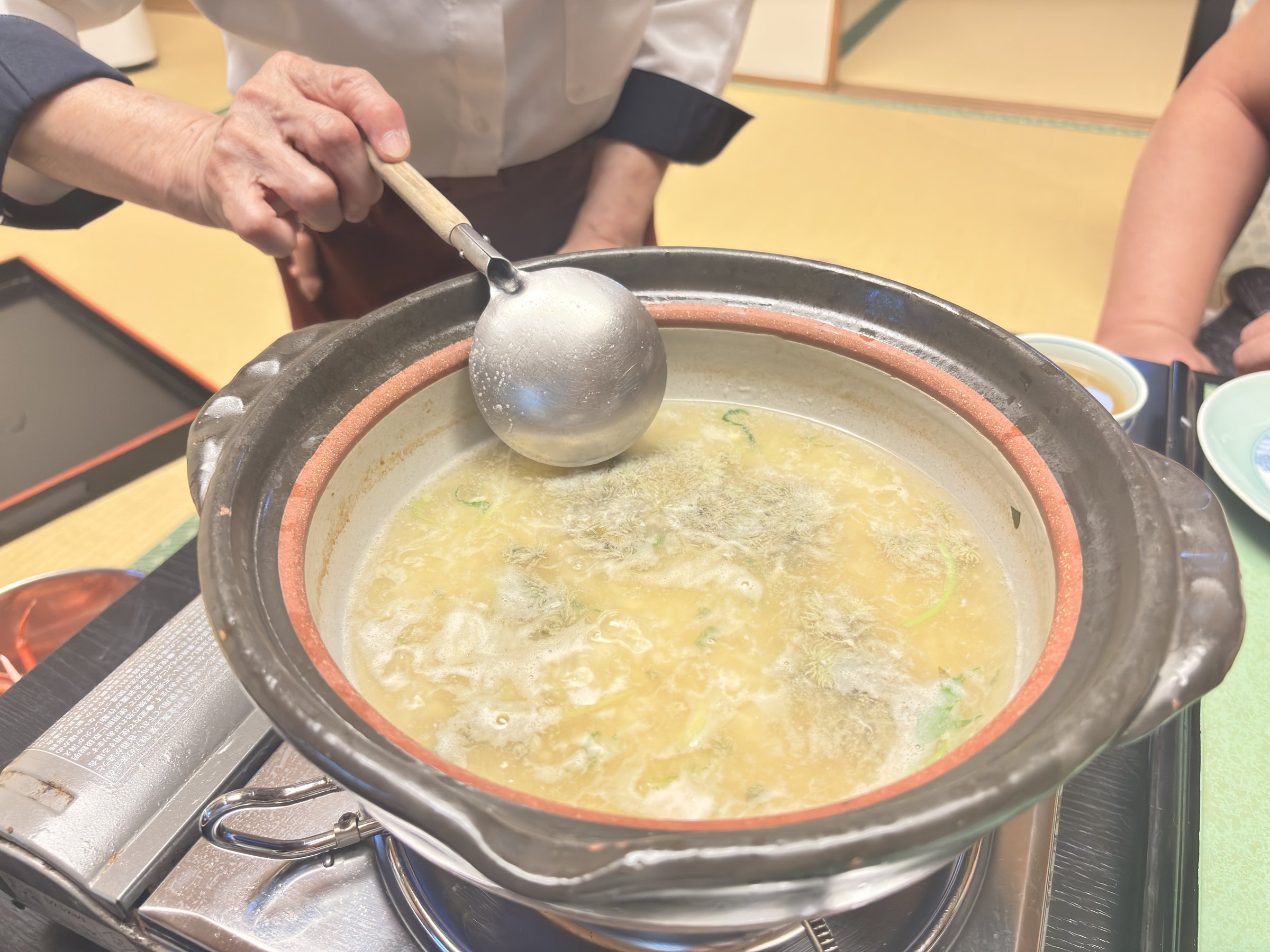 Our server stirring beaten egg into the rice in the pot.