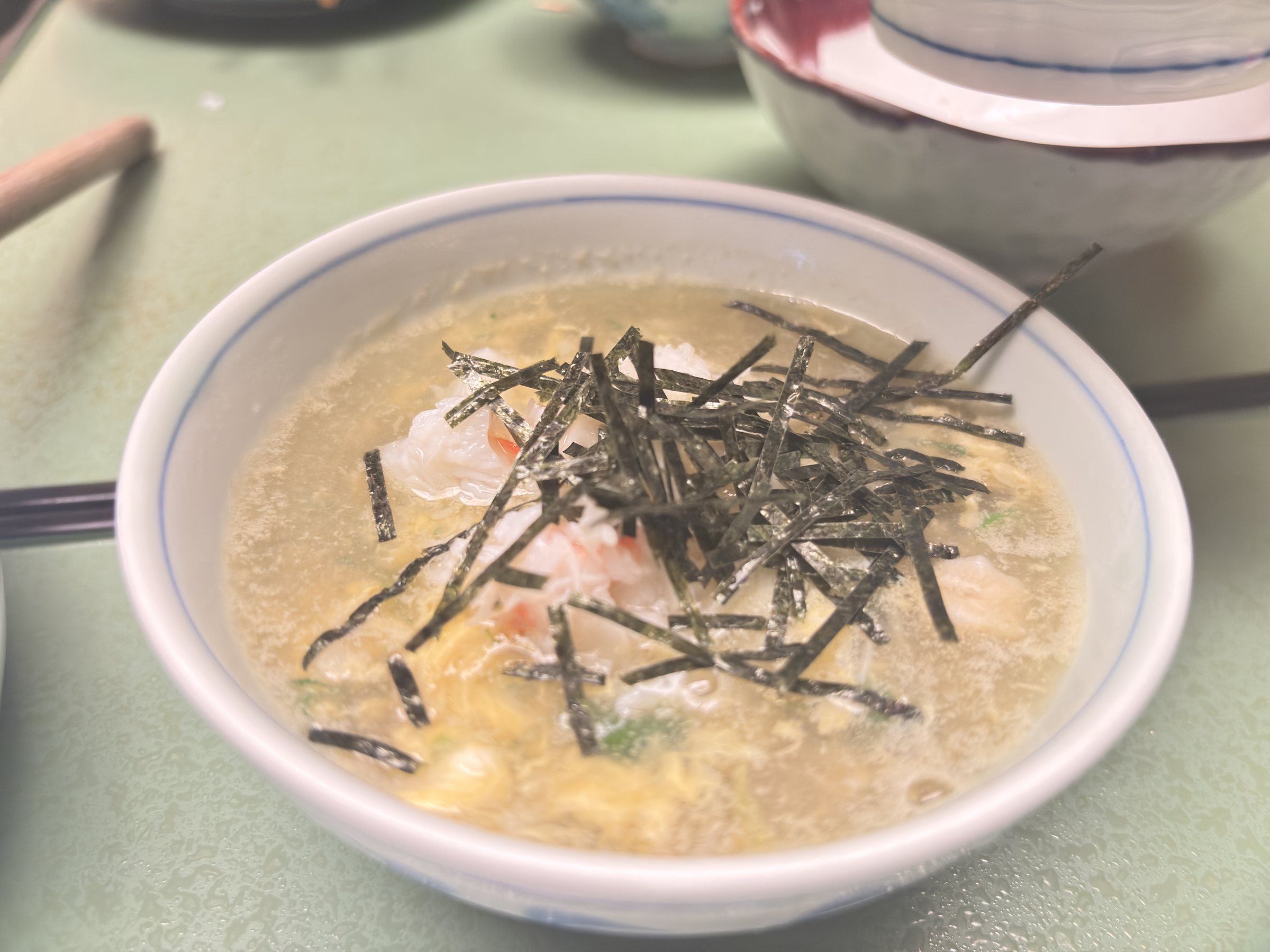 Crab zosui topped with shredded nori.
