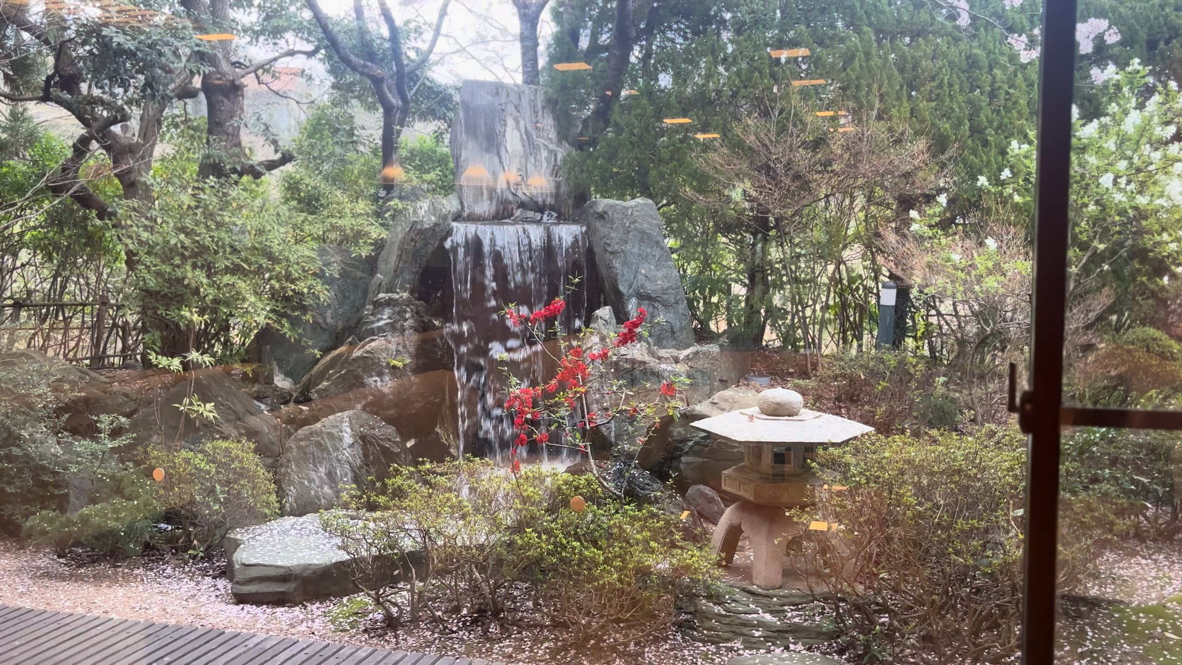 A garden waterfall with a stone lantern.