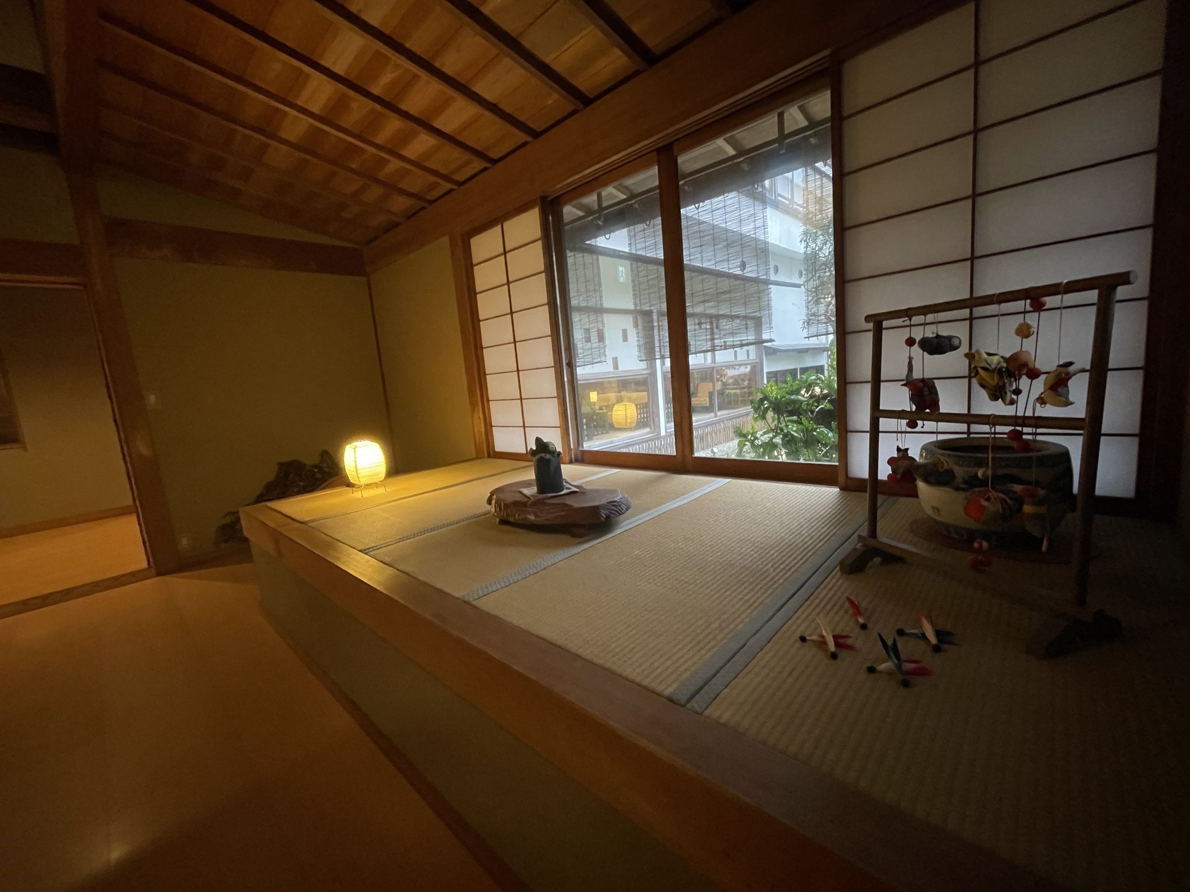 A raised tatami alcove by the window, with a small seasonal display.