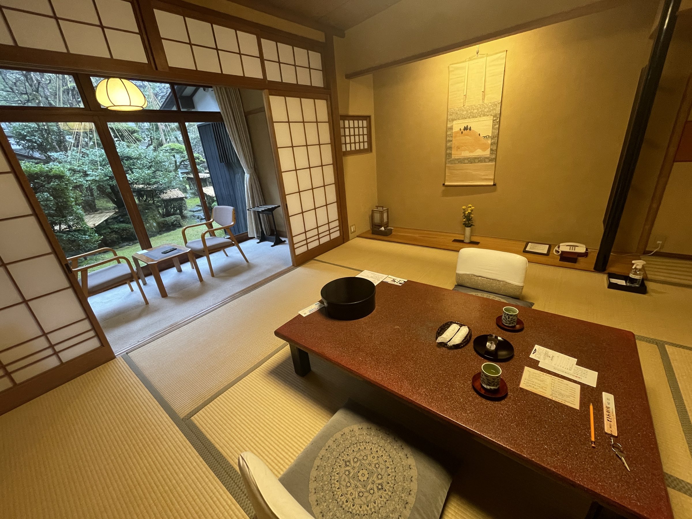 The tatami room, with a low lacquered table and windows onto the garden.
