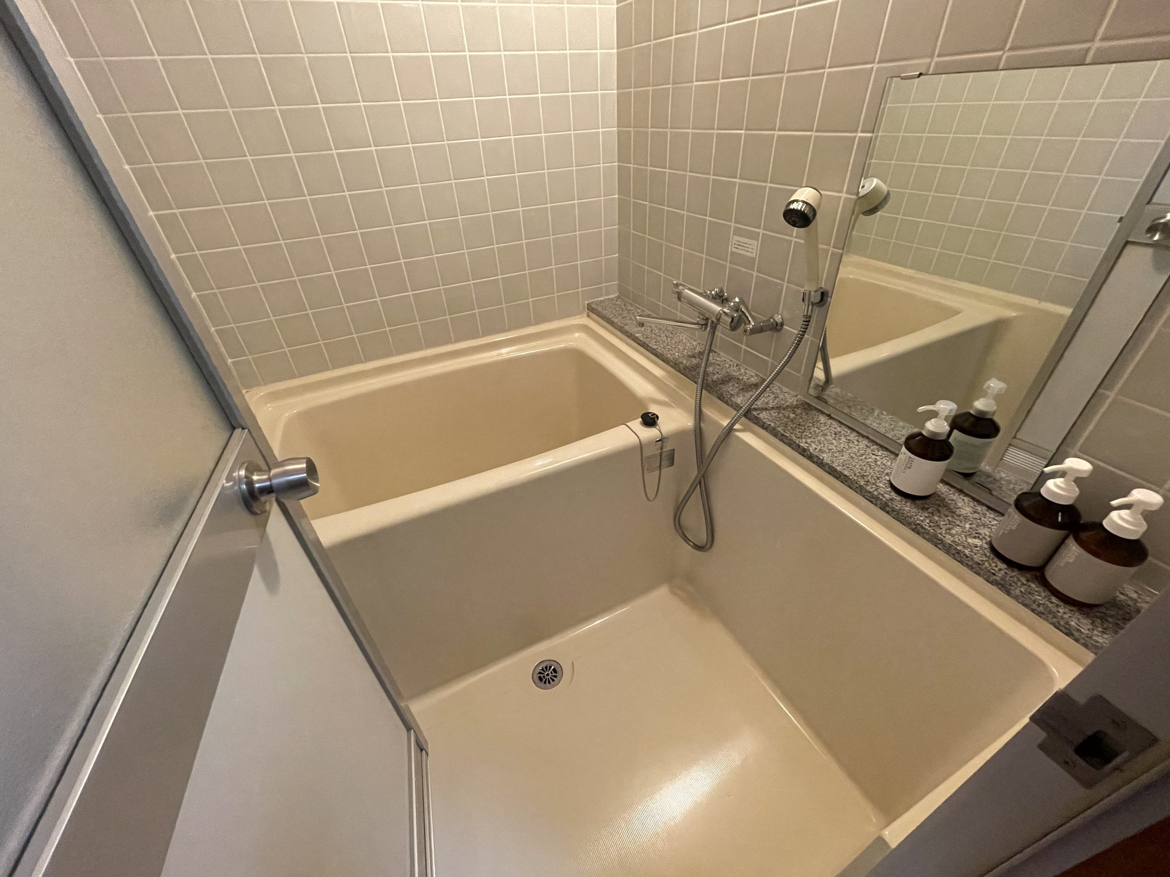The room’s compact tiled bathroom.