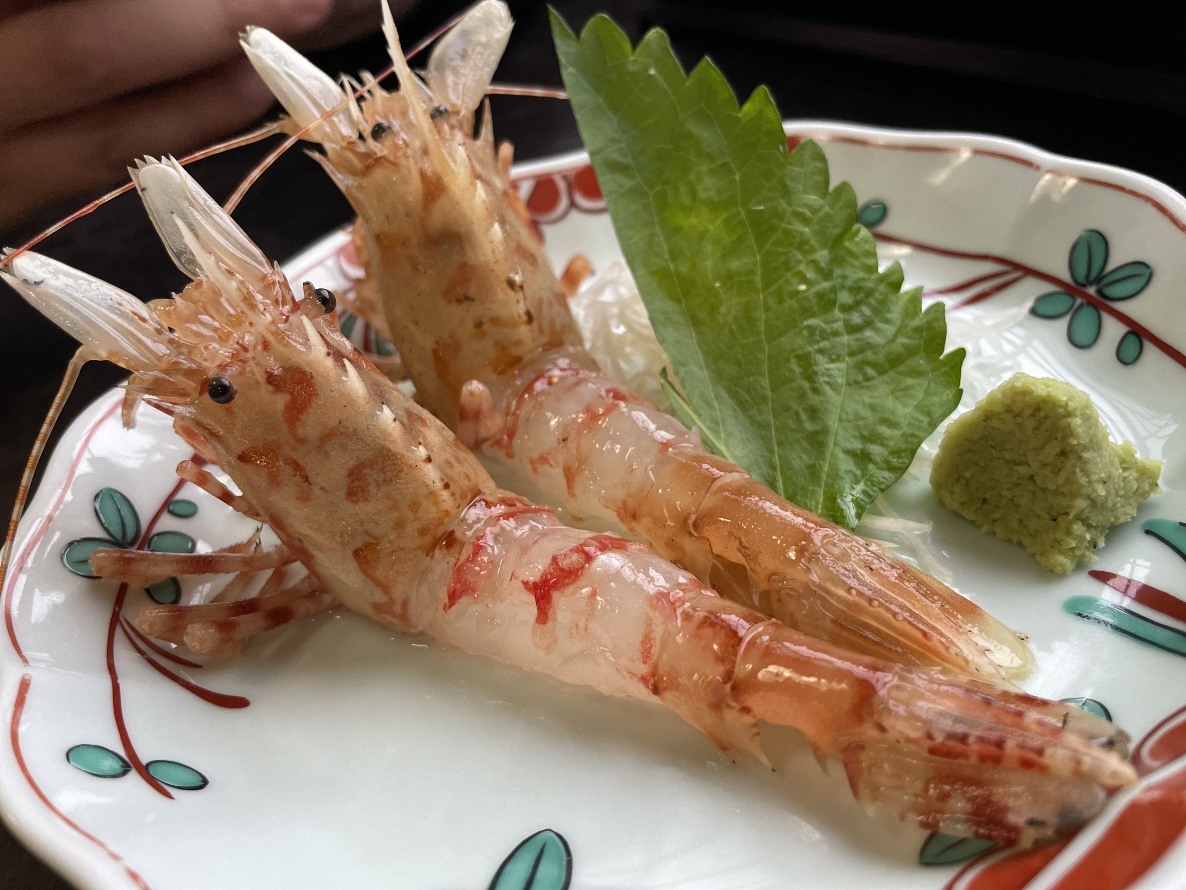 Oni-ebi shrimp served as sashimi, with shiso and wasabi.