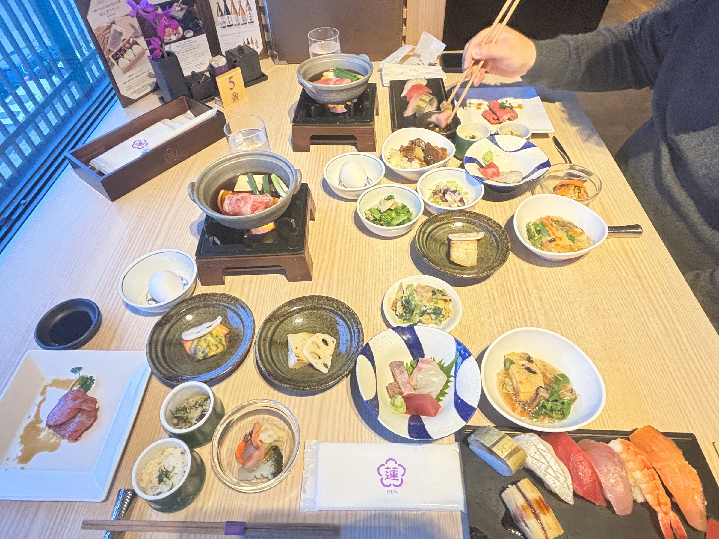 Our table: sukiyaki, sashimi, sushi and small dishes from the buffet.
