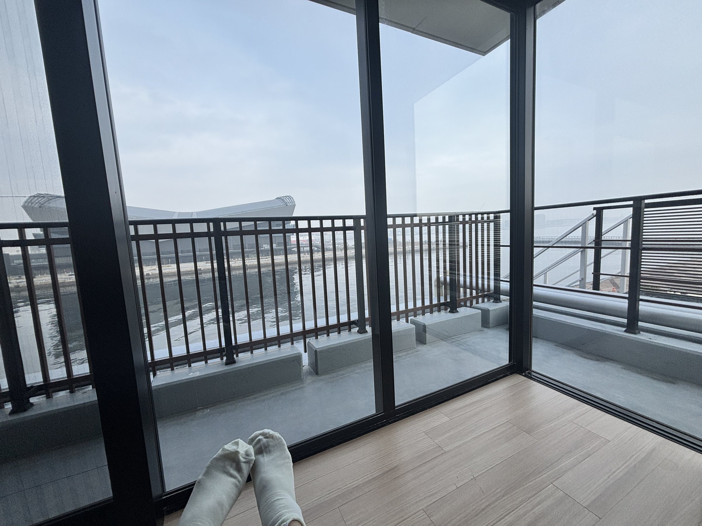Stretching out by the full-height windows.