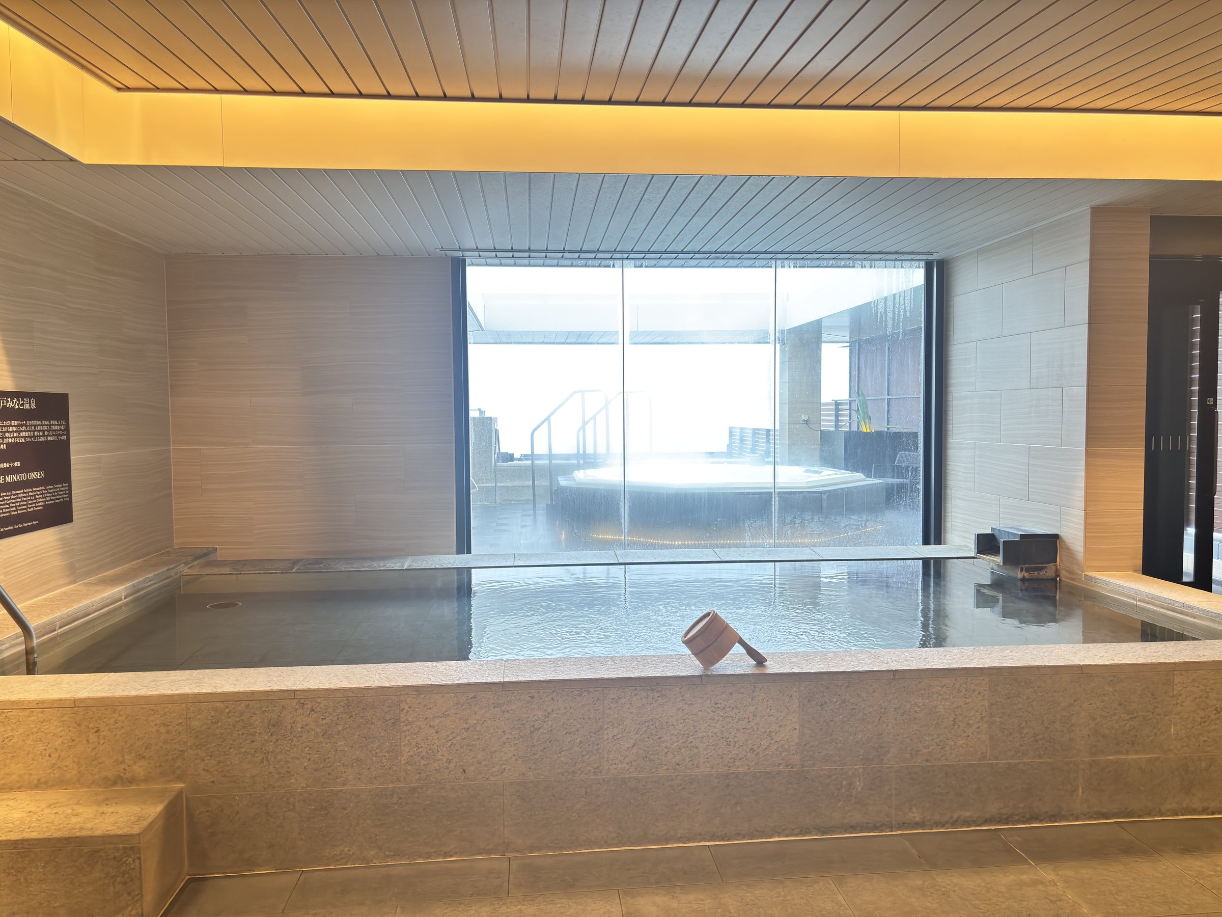 Another indoor bath under a warmly lit wooden ceiling.