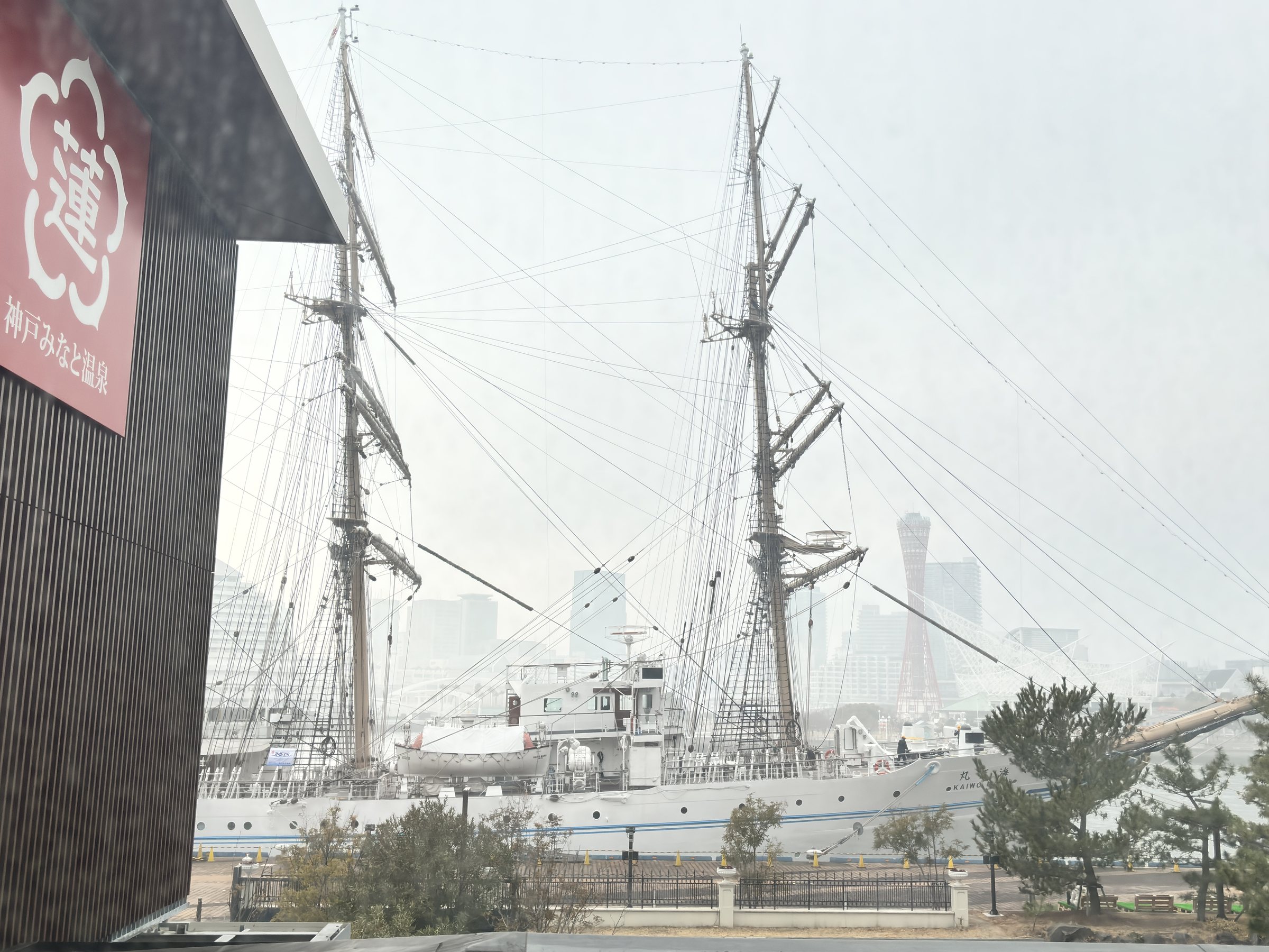 A tall ship moored outside, seen through the window on the way to the baths.