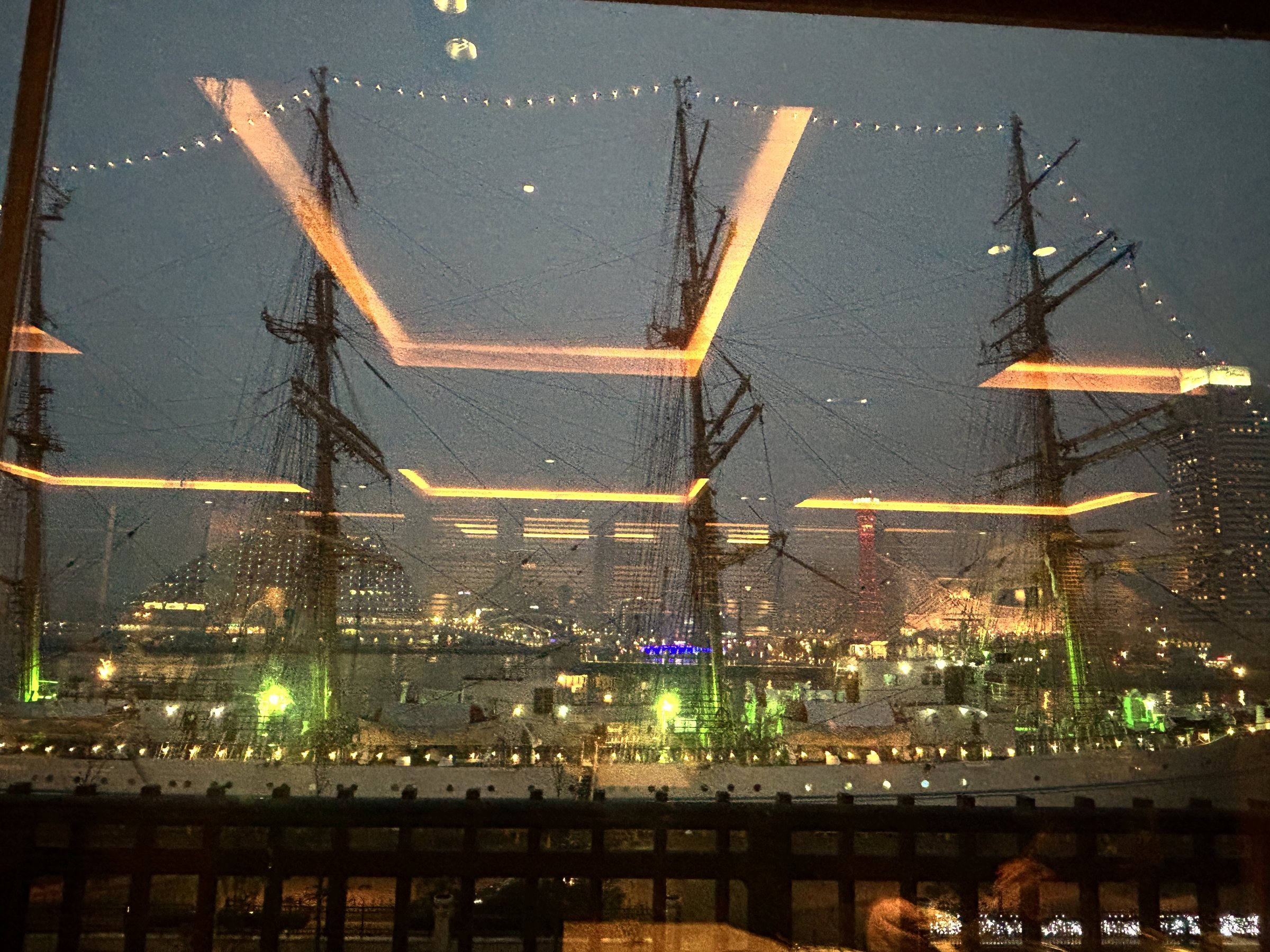 The illuminated tall ship, seen from the bar.