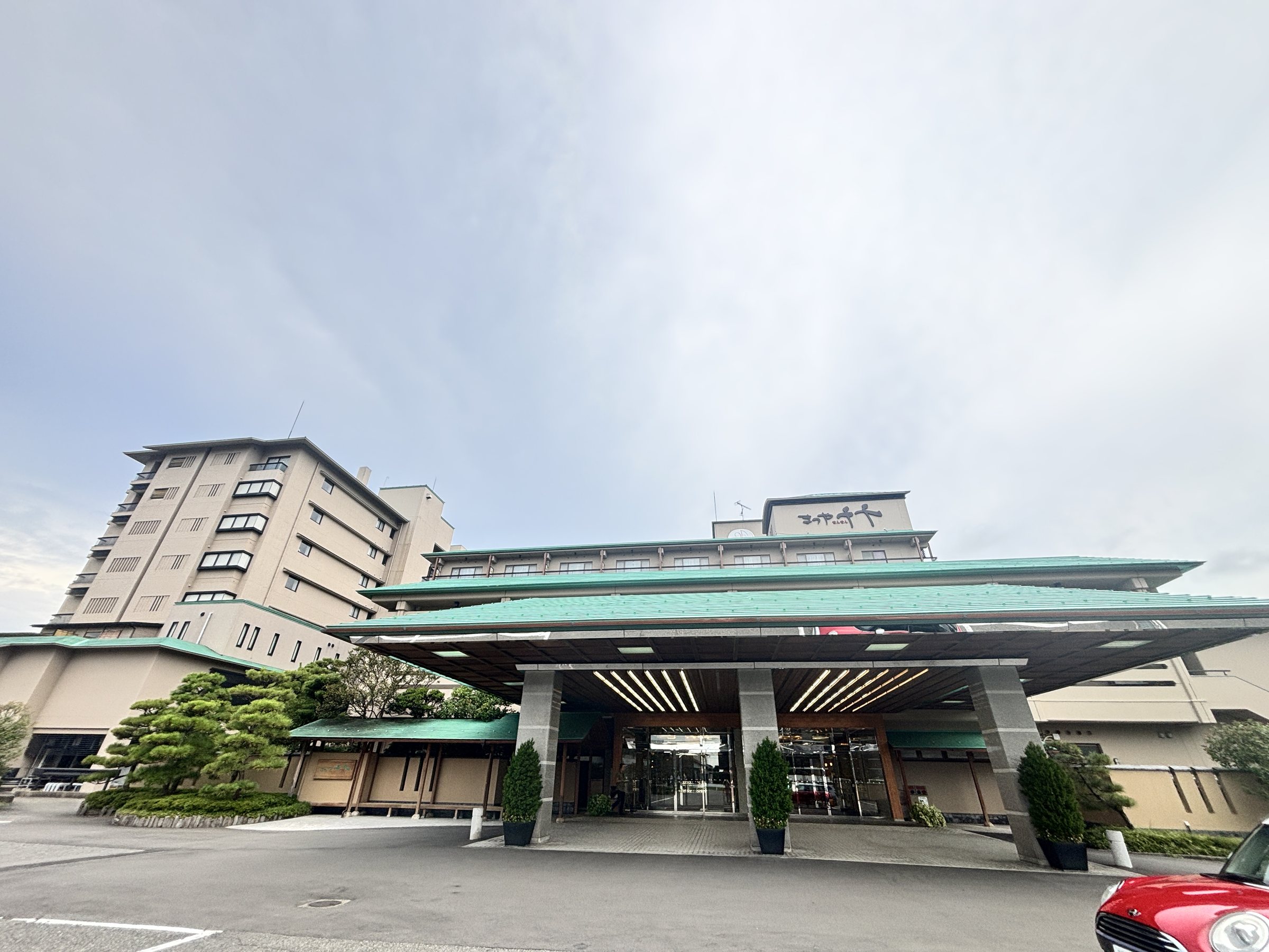 The main building and its green-roofed porte-cochère.