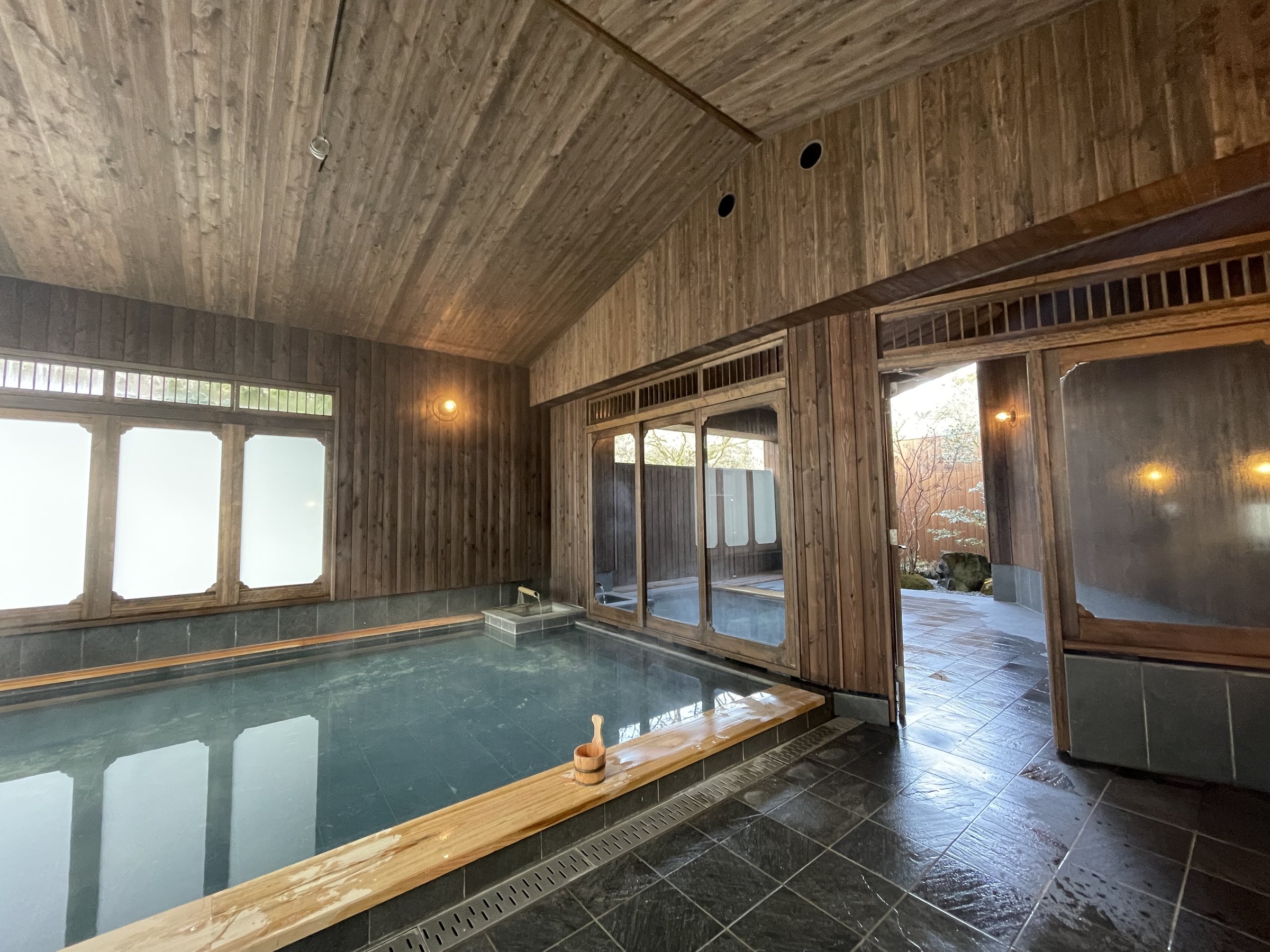 The main bath from another angle, with the door to the open-air bath beyond.