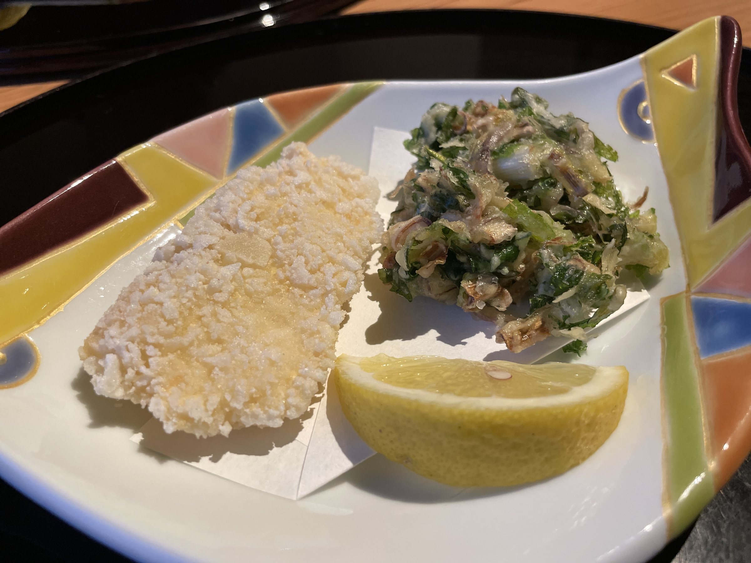 Fried sea bream and a vegetable kakiage, with a wedge of lemon.