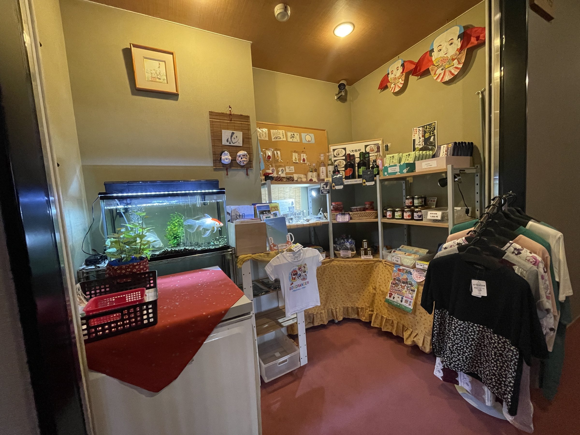 The shop corner, with local products, souvenirs and a fish tank.