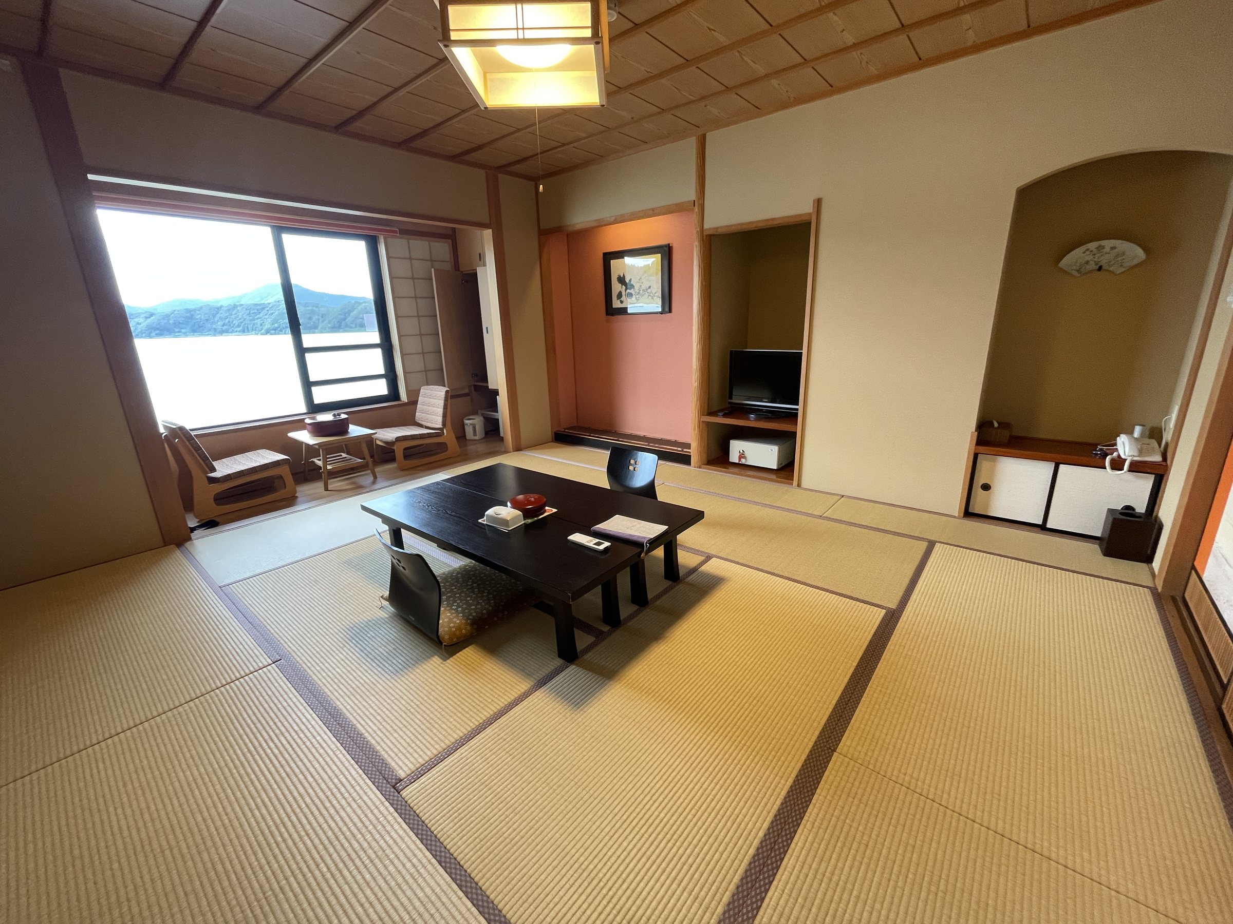 The tatami room, with a low table and the lake visible through the window.
