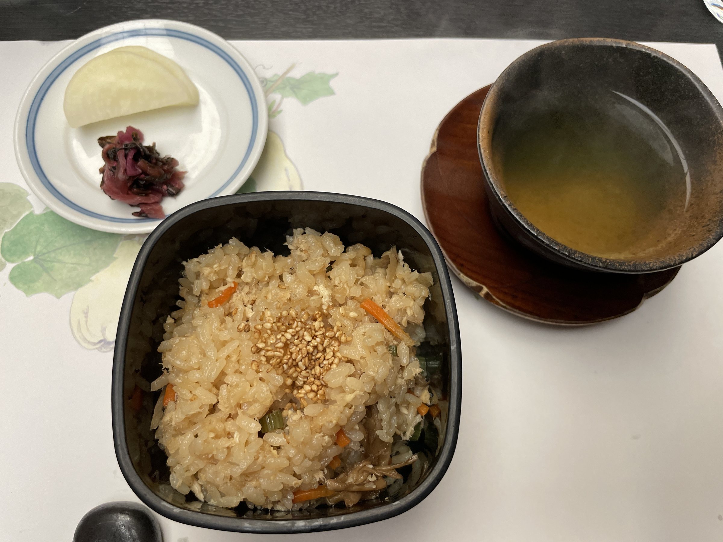 Mixed rice in a lacquered box, with miso soup and pickles.
