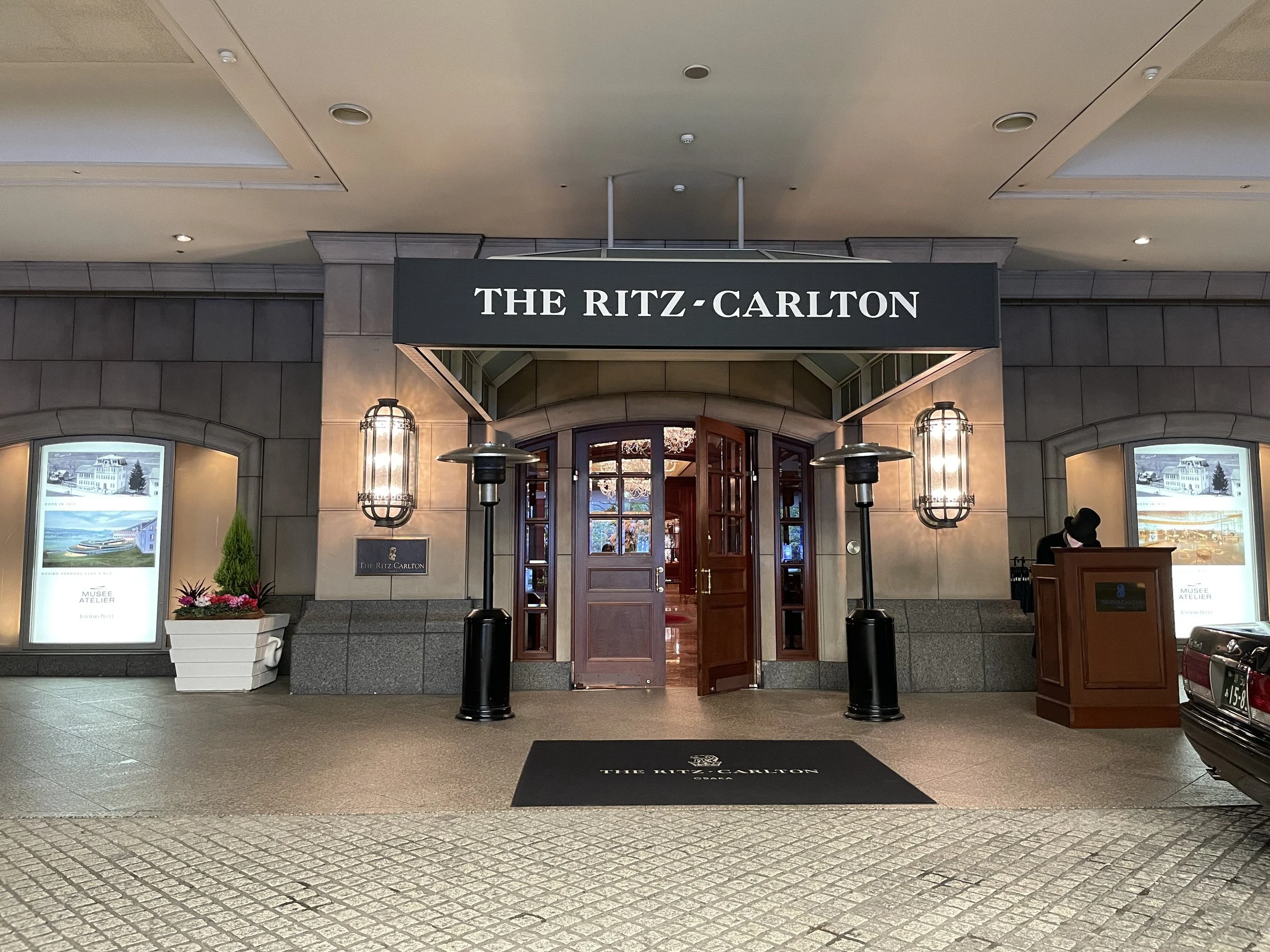 The main entrance under a dark canopy bearing the hotel's name.