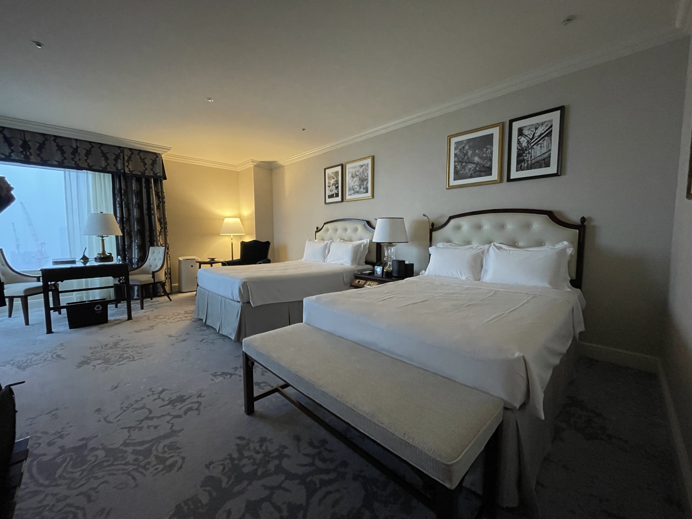Twin beds with tufted headboards and crisp white linen.