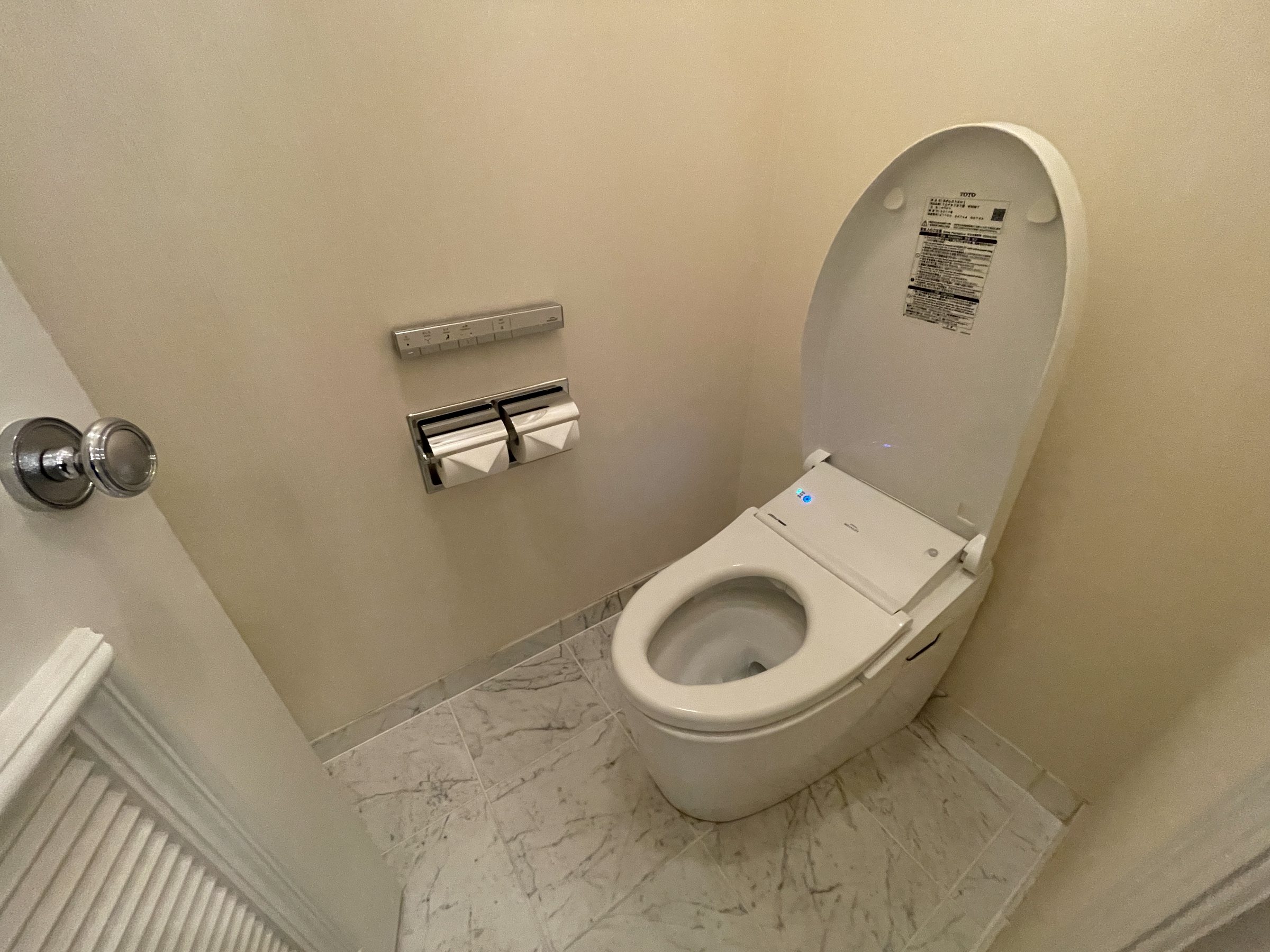 The toilet, set in its own marble room.