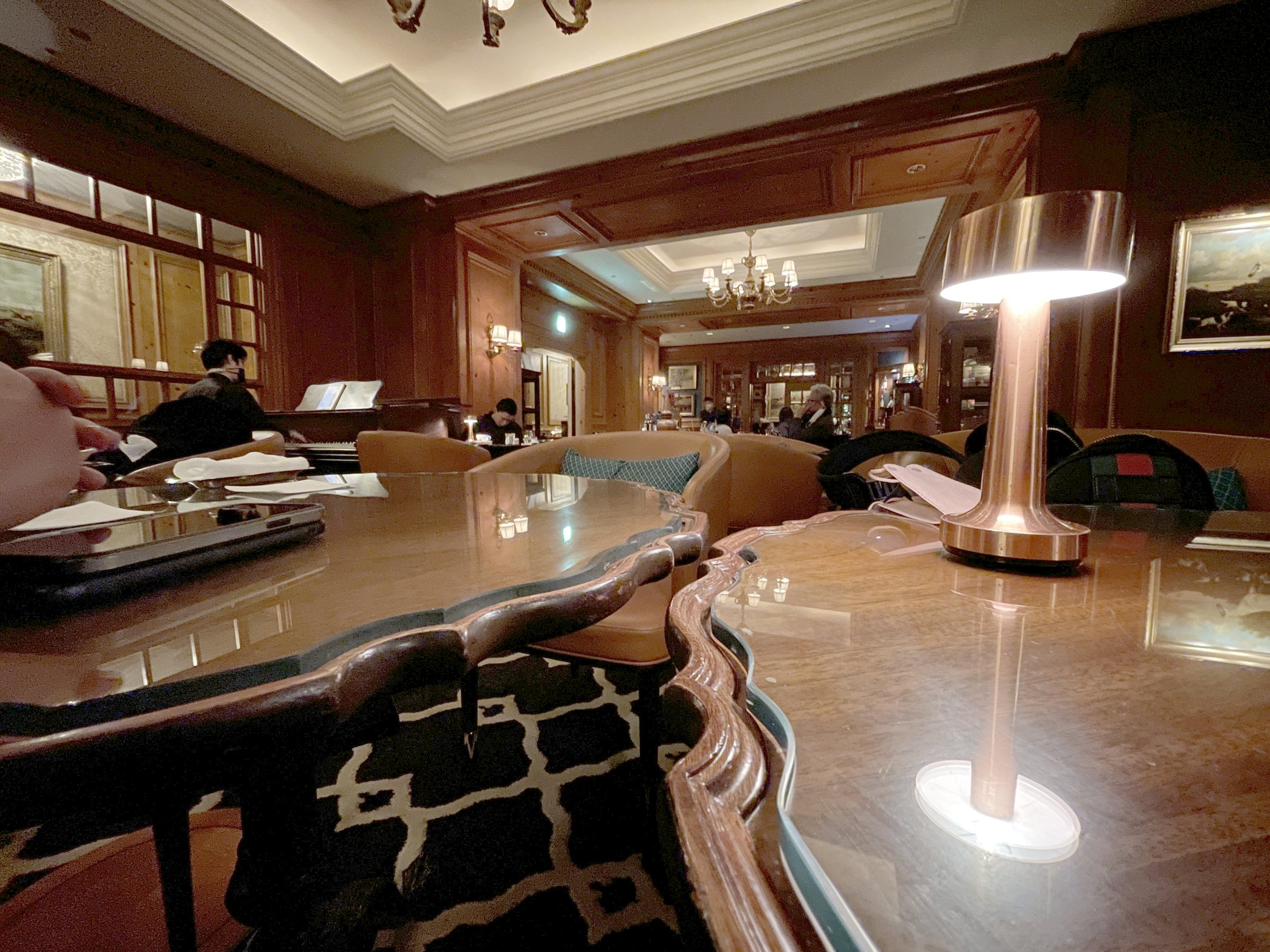 The wood-paneled lounge bar in low lamplight.