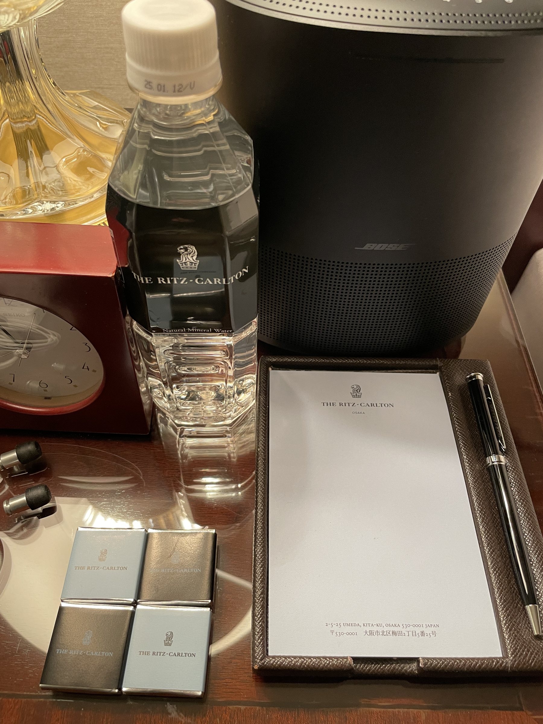 Bedside: the hotel's own chocolates, a notepad and a bottle of water.