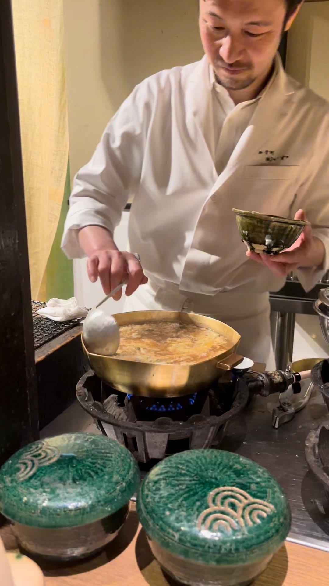 Making porridge in the brass pan at the counter.