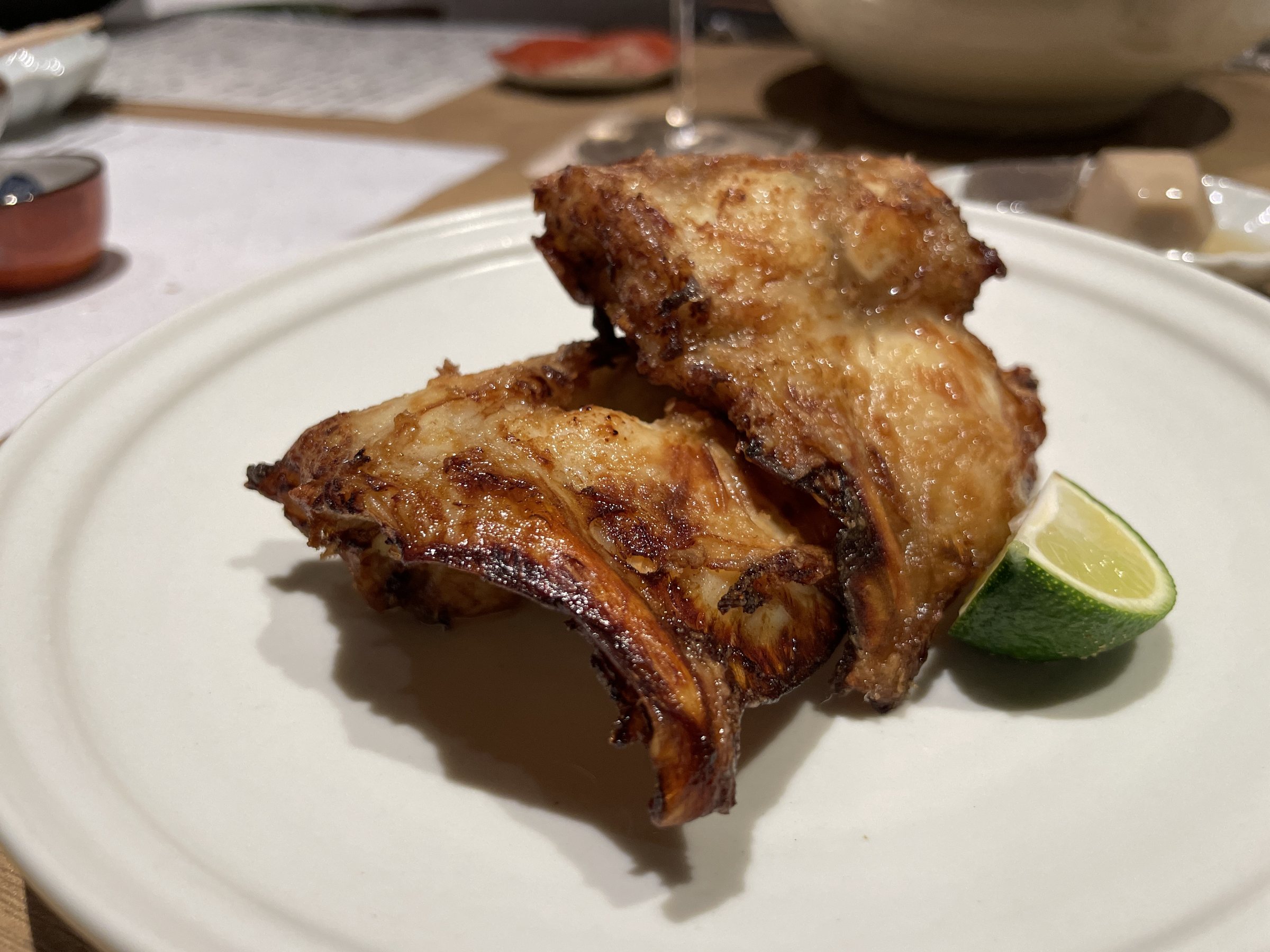 Glazed, grilled fugu with a wedge of sudachi.