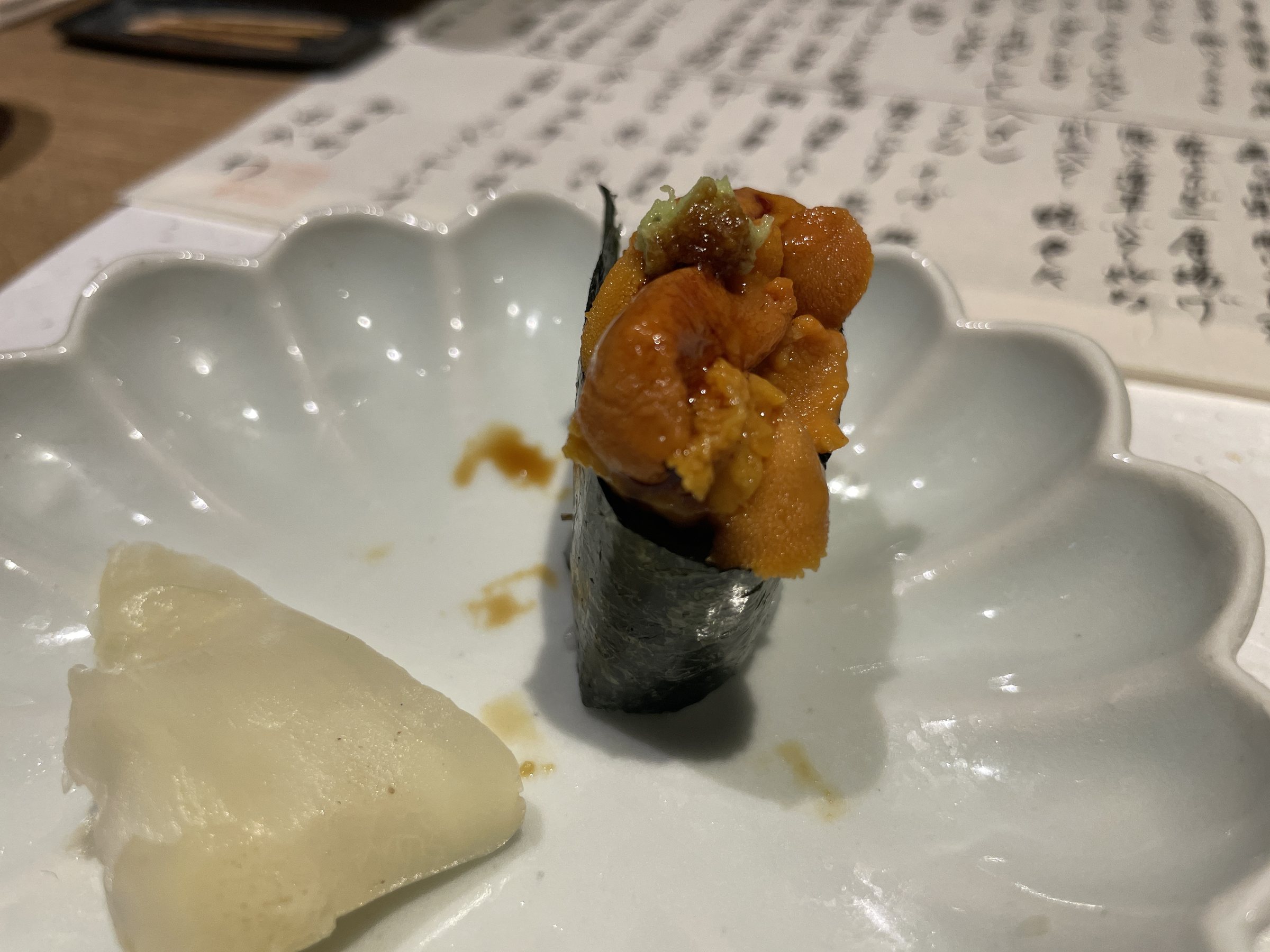Sea urchin sushi wrapped in nori, with pickled ginger.