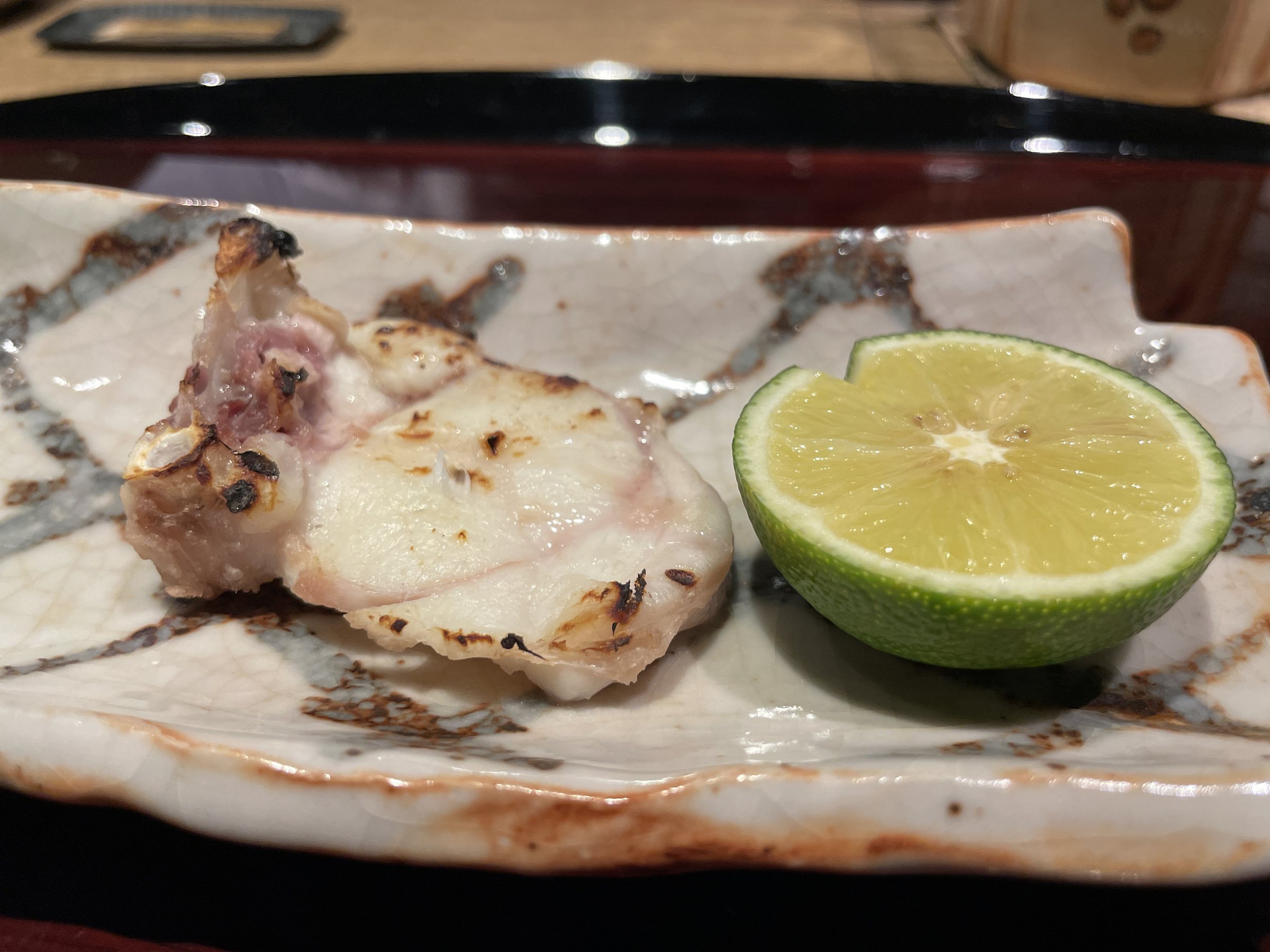 Grilled fugu with half a kabosu.
