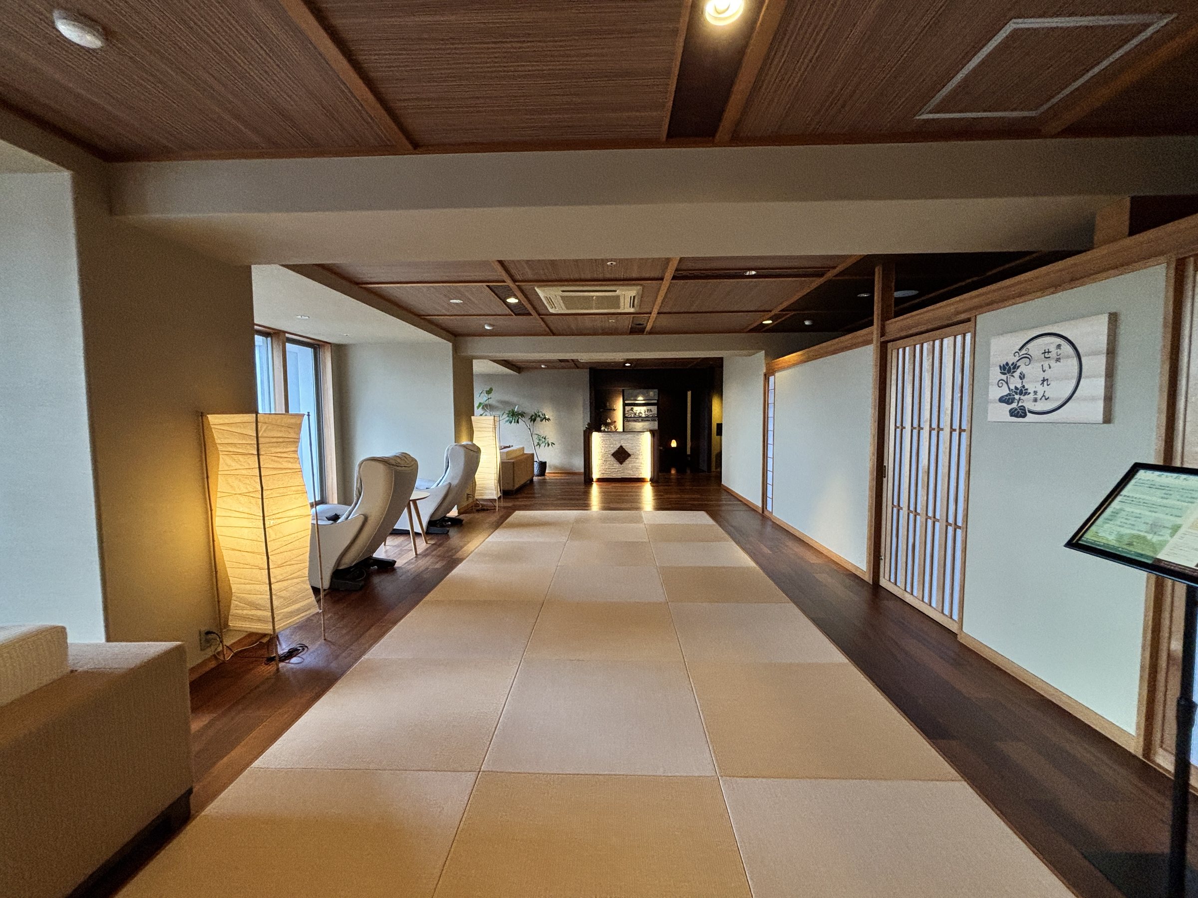 A long corridor lined with massage chairs.