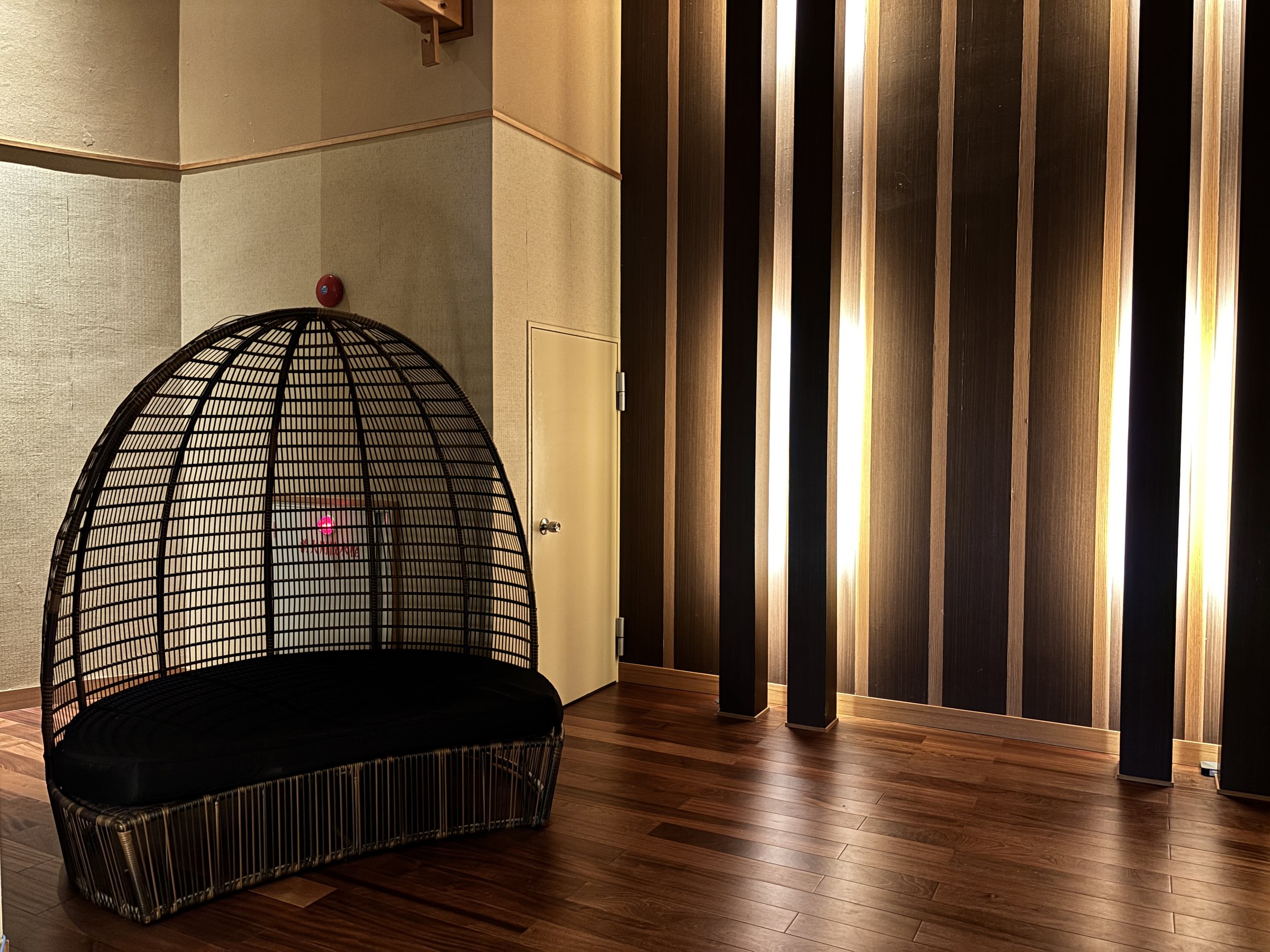 A hanging basket chair by the bath entrance.