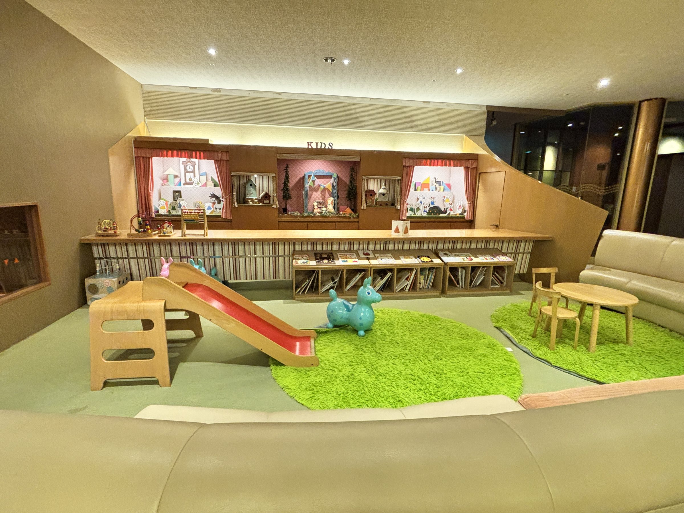 The kids' corner, with a slide and play mats.