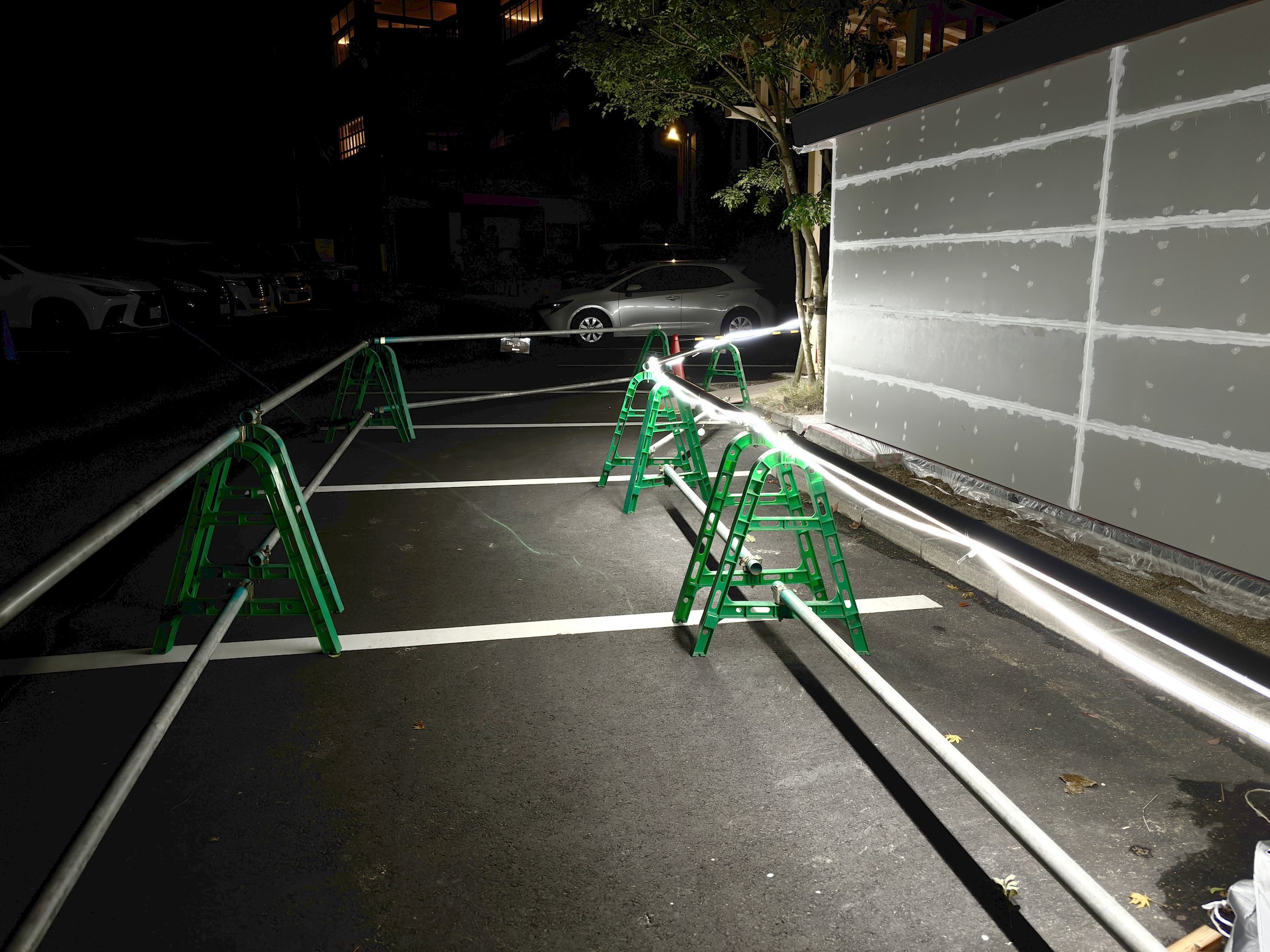 The path to the annex baths at night, beside a construction area.