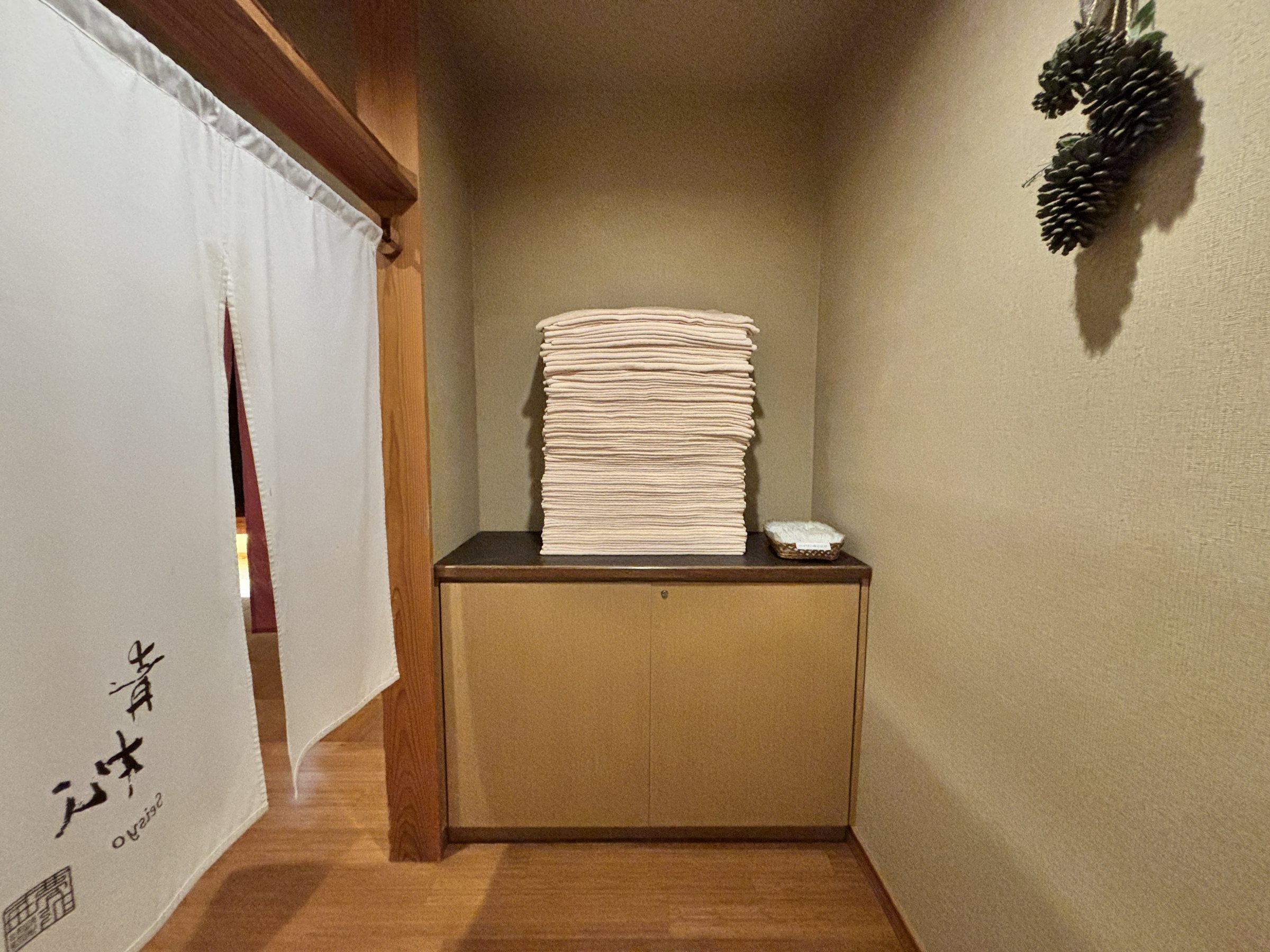 The curtained entrance, with stacked towels.