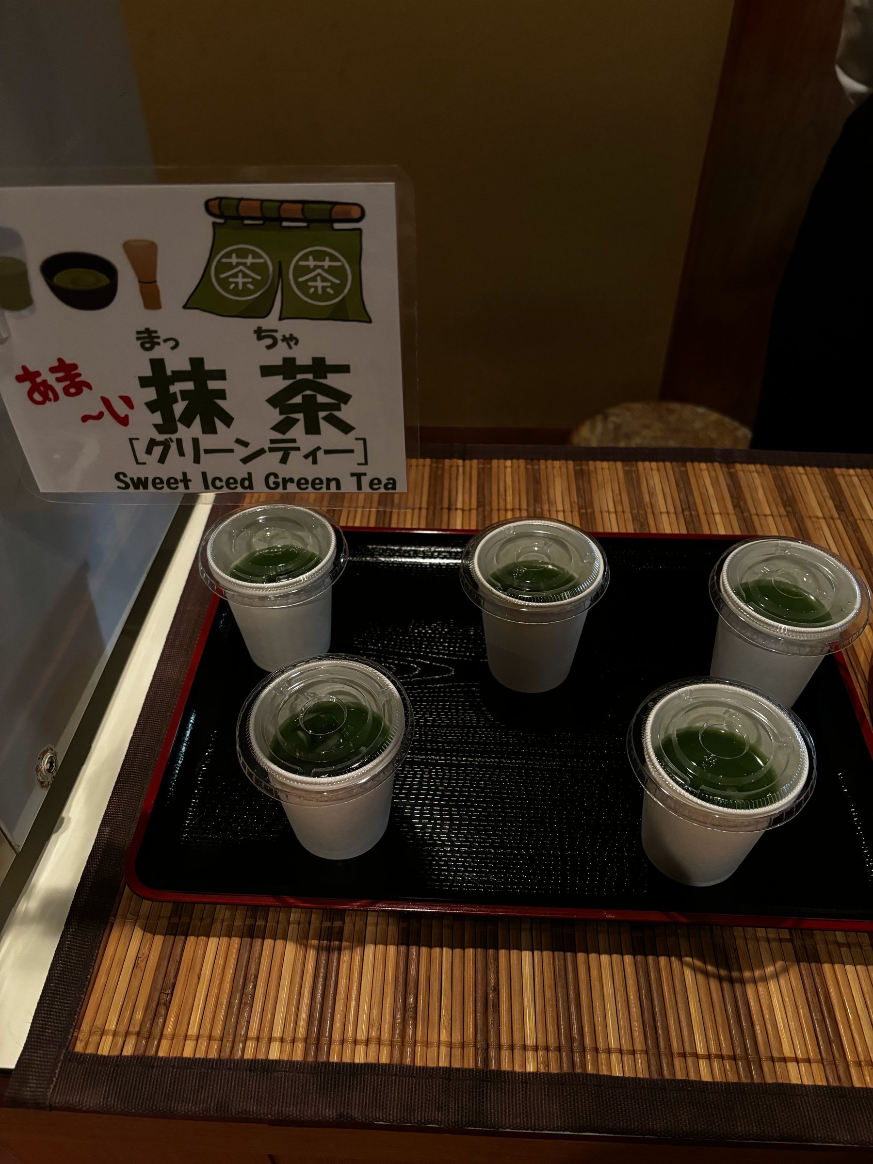 Lidded cups of sweet iced green tea, set out after the bath.