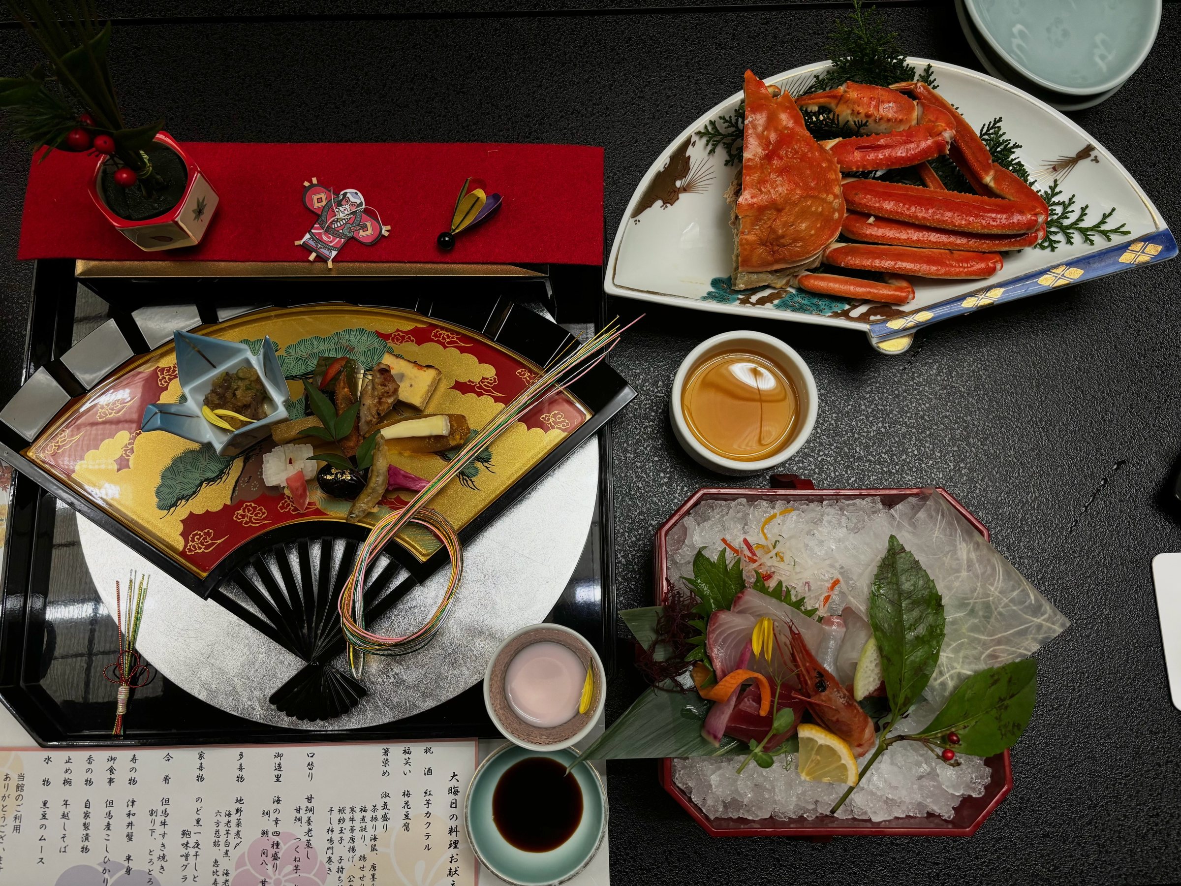 The opening course: crab on a fan-shaped plate, the decorative platter and sashimi on ice.