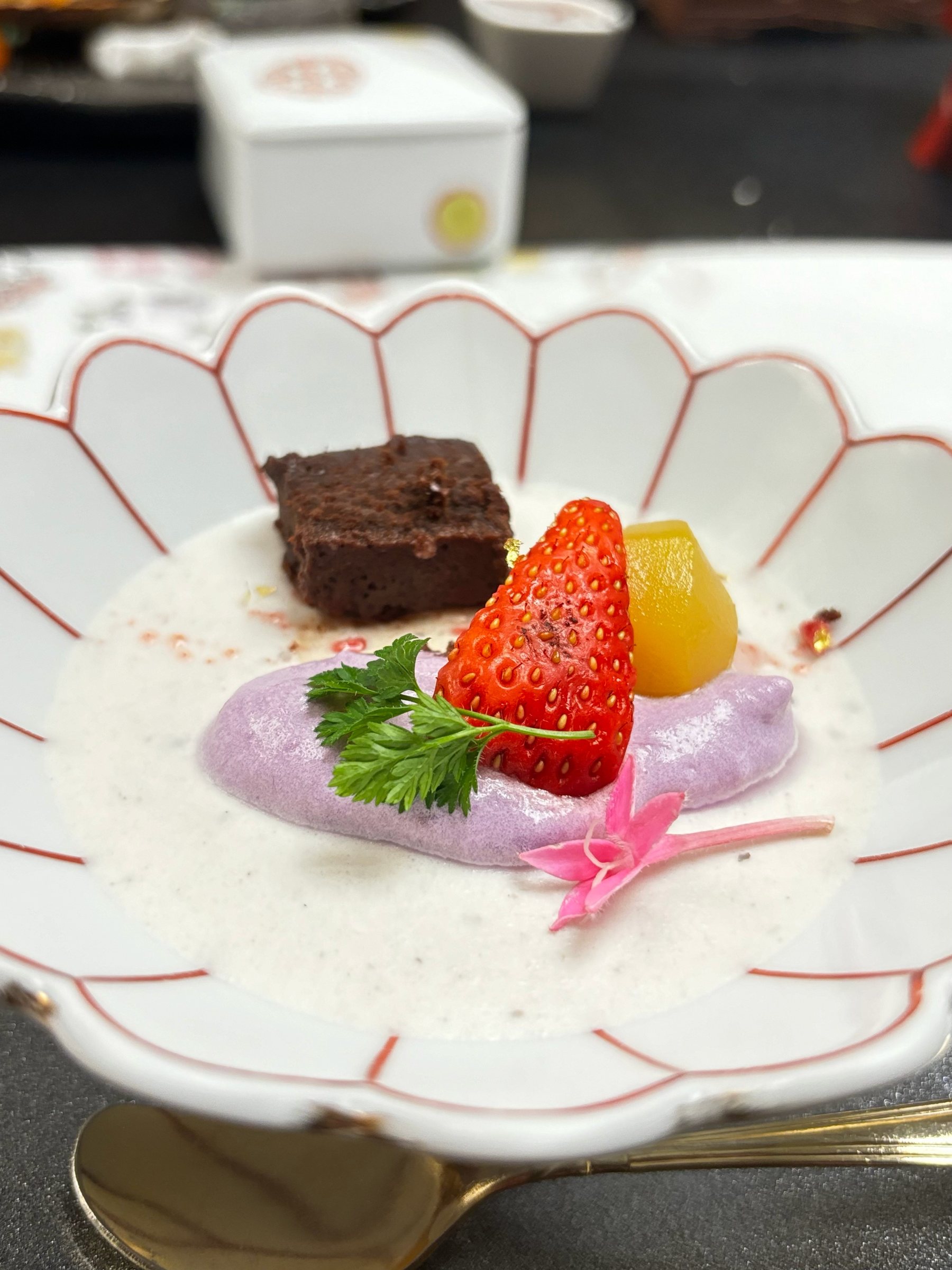 Dessert: white mousse with purple sweet potato sauce, strawberry, brownie and chestnut.
