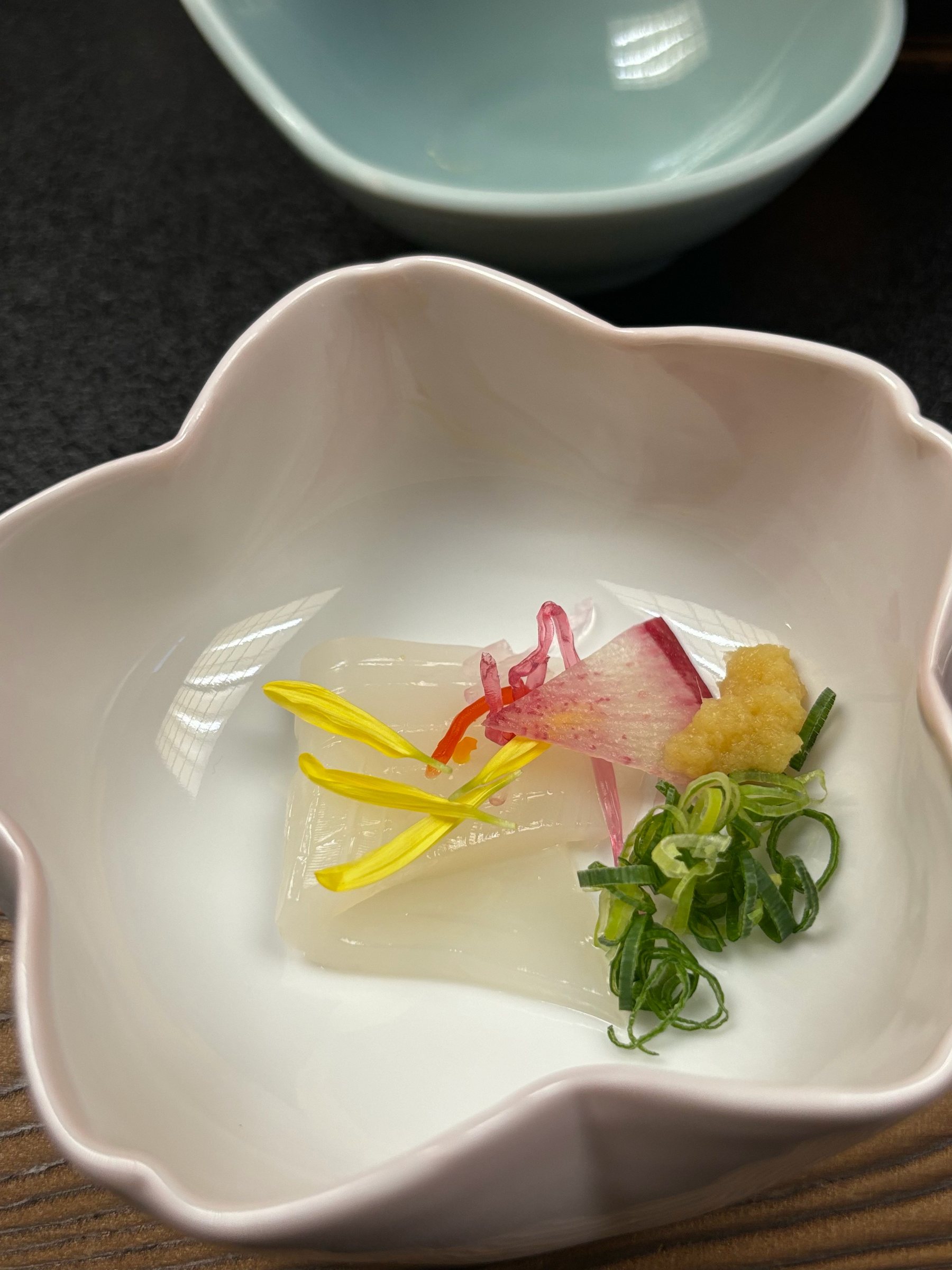 Squid sashimi in a flower-shaped bowl.